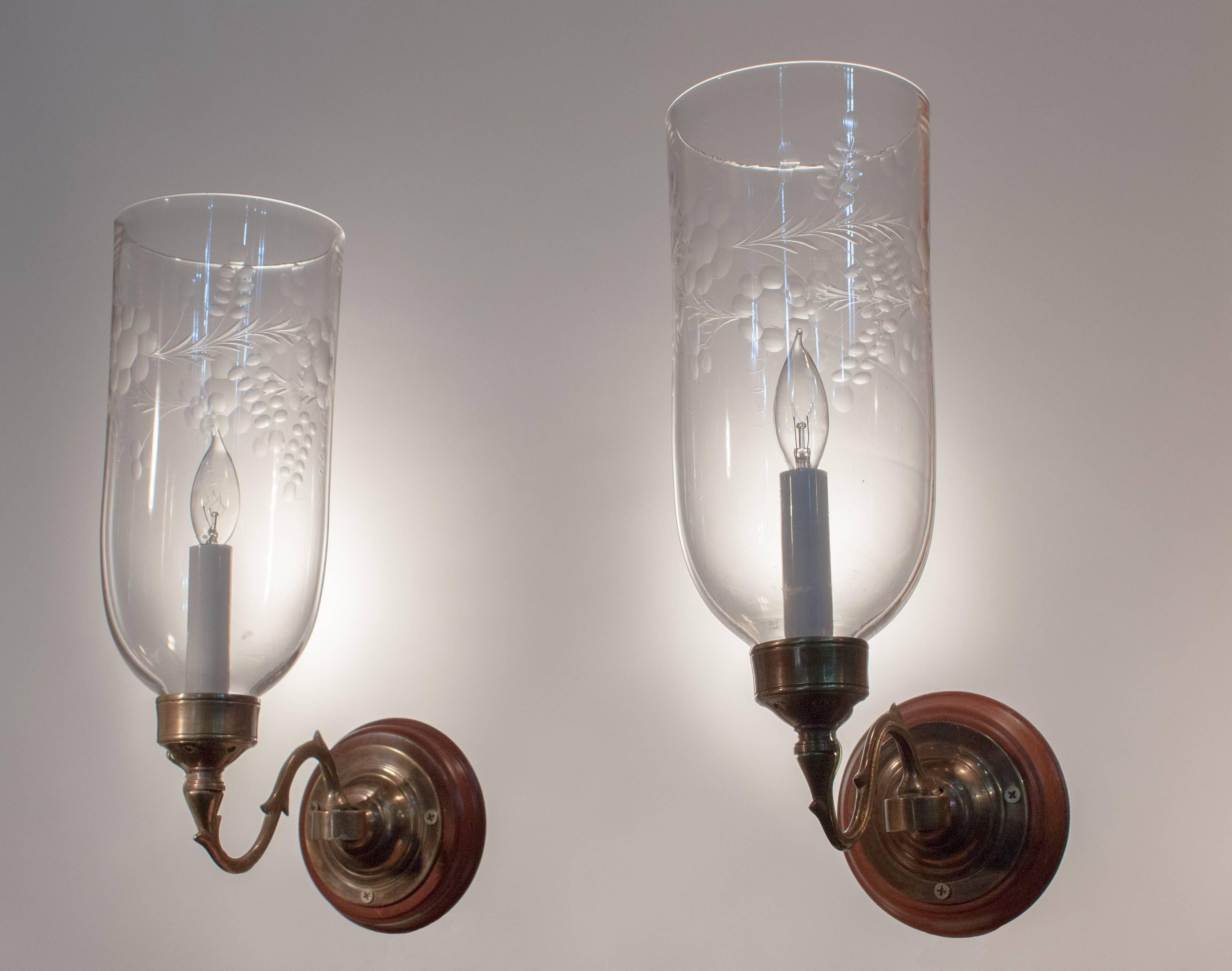 Beautiful pair of 19th century English hurricane sconce shades with straight form and a tasteful flower/vine etching. The quality of the handblown glass is excellent, including subtle swirling and air bubbles. Originally for candles, the wall