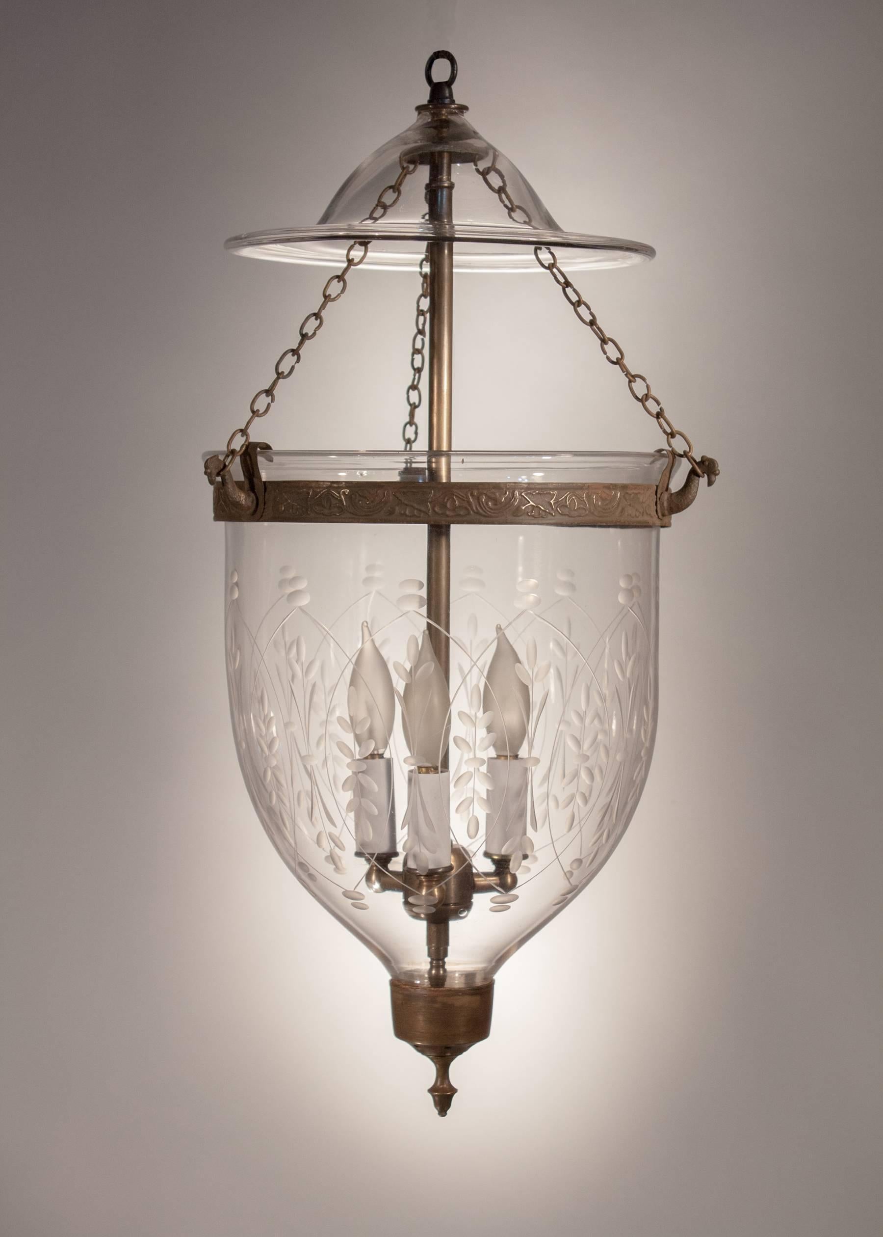 A classic, handblown glass bell jar lantern with an etched wheat motif that accents the contour of this authentic lantern. The smoke bell is period and the brass accents are original with the exception of the embossed band, which has been replaced