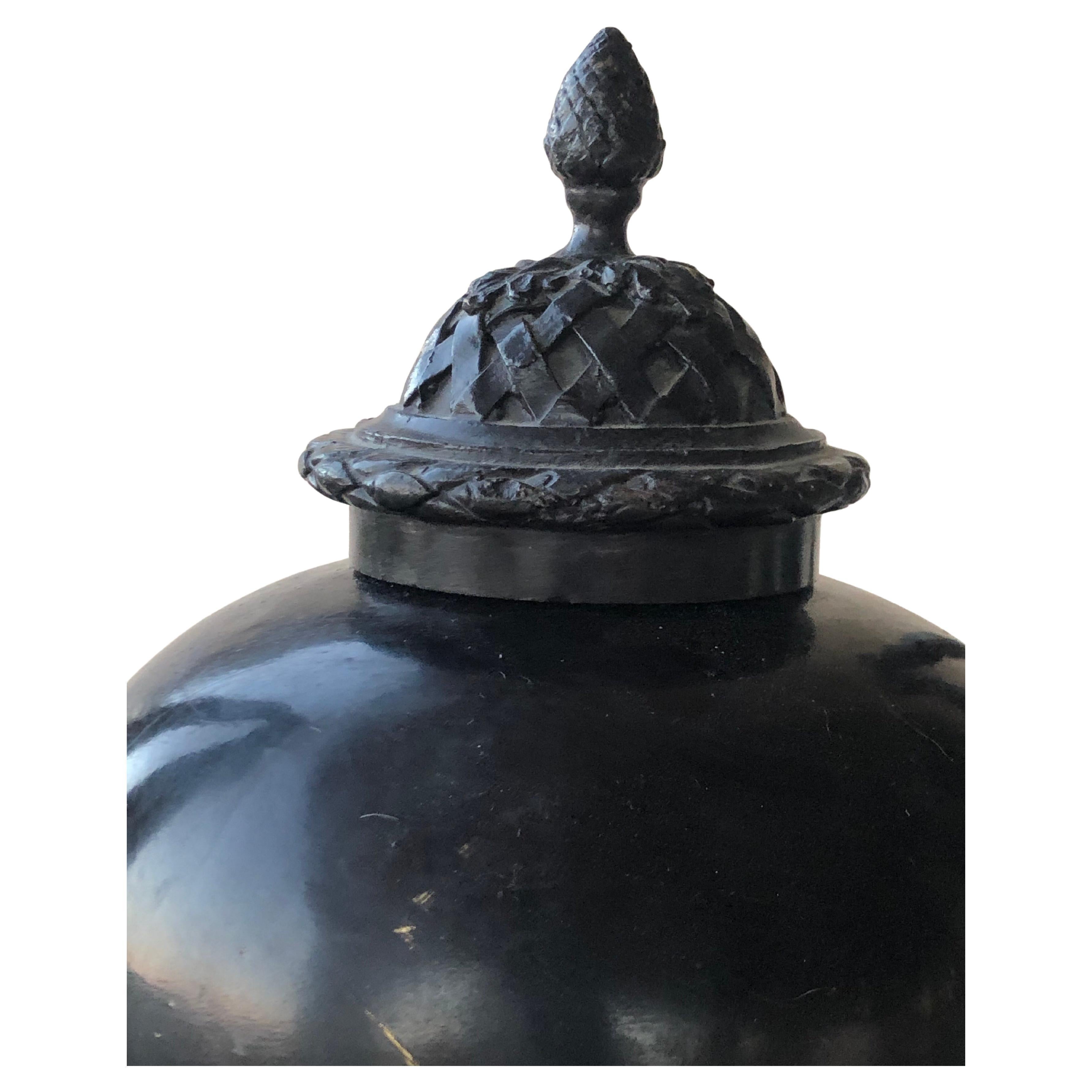 This lovely and very heavy urn was designed and made by Maitland Smith. Detail on the piece is amazing with beautiful handles with the face of a woman and intricate bronze top. From a very chic Palm Springs estate.