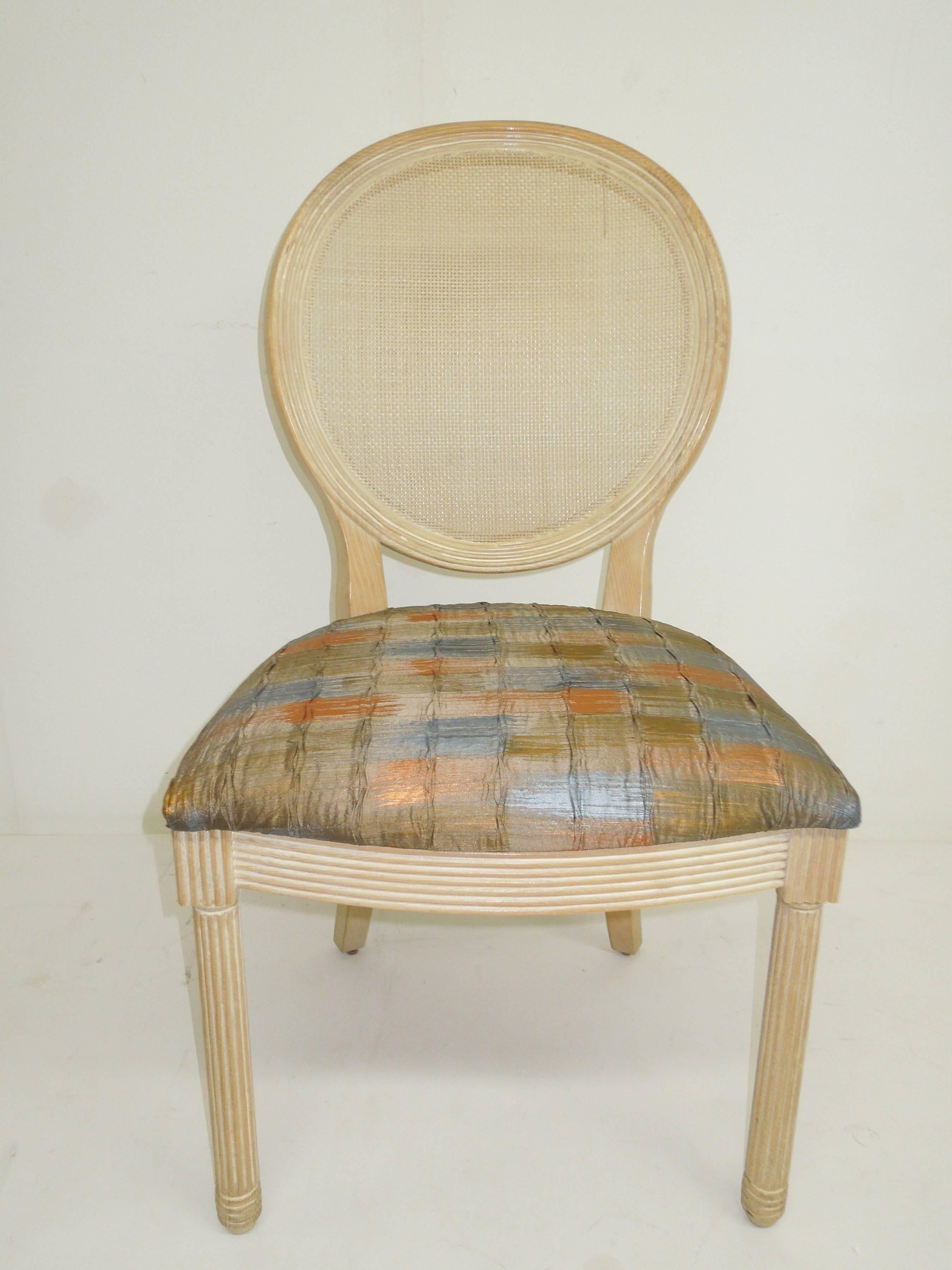 Jay Spectre's interpretation of a Classic Louis XVI form. Set of four dining or game chairs for Century Furniture, circa 1984. In original Iconic cerused oak finish. Woven cane backs. Newly reupholstered in European plaid rayon metallic pleated
