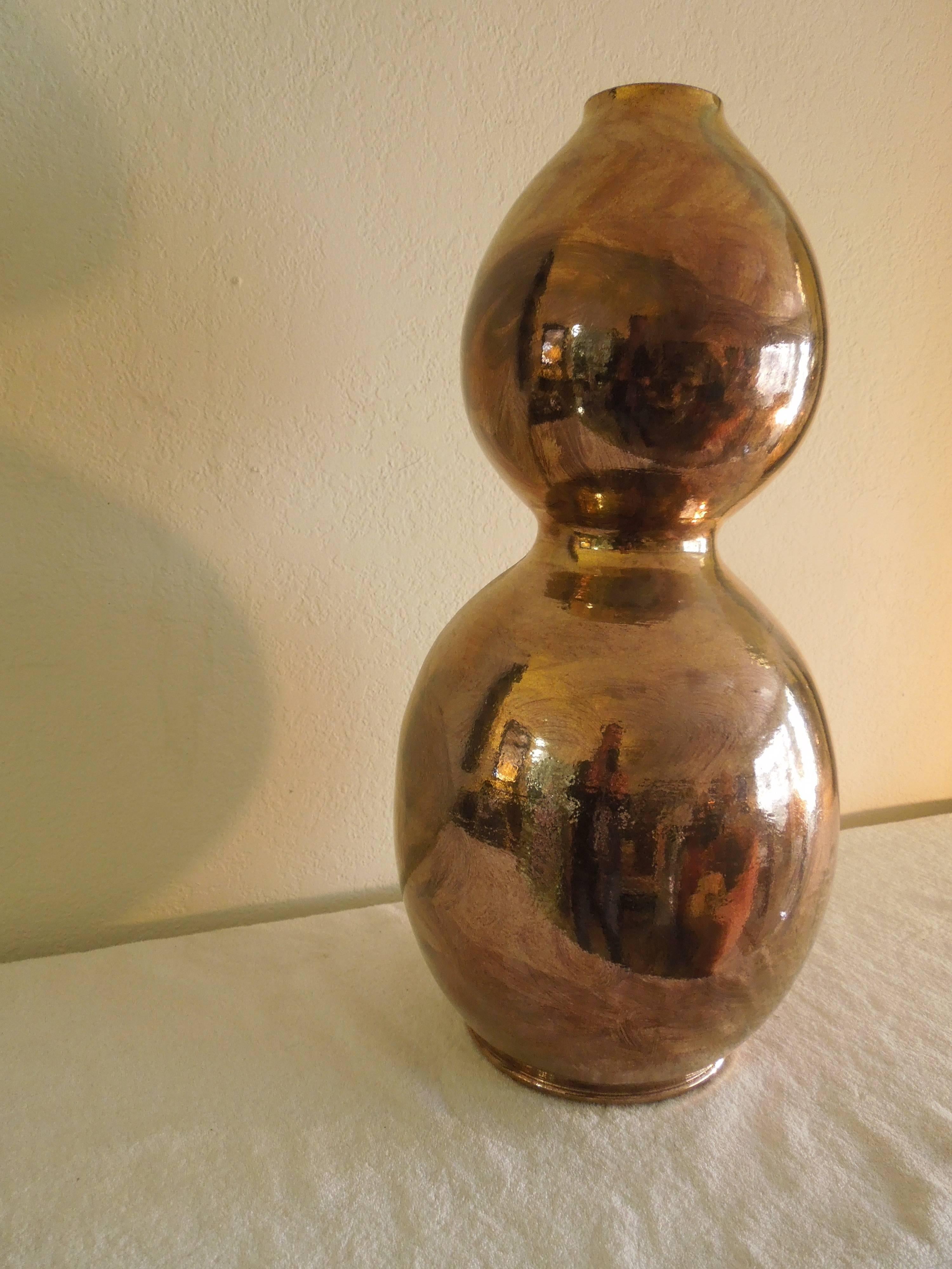A large metallic bronze color glaze vase by artist Guy Mc Cloy. Mr. Mc Cloy did custom ordered pottery for Palm Springs designer Steve Chase. This piece was in the living room of a Palm Springs estate entirely designed by Mr. Chase in the early