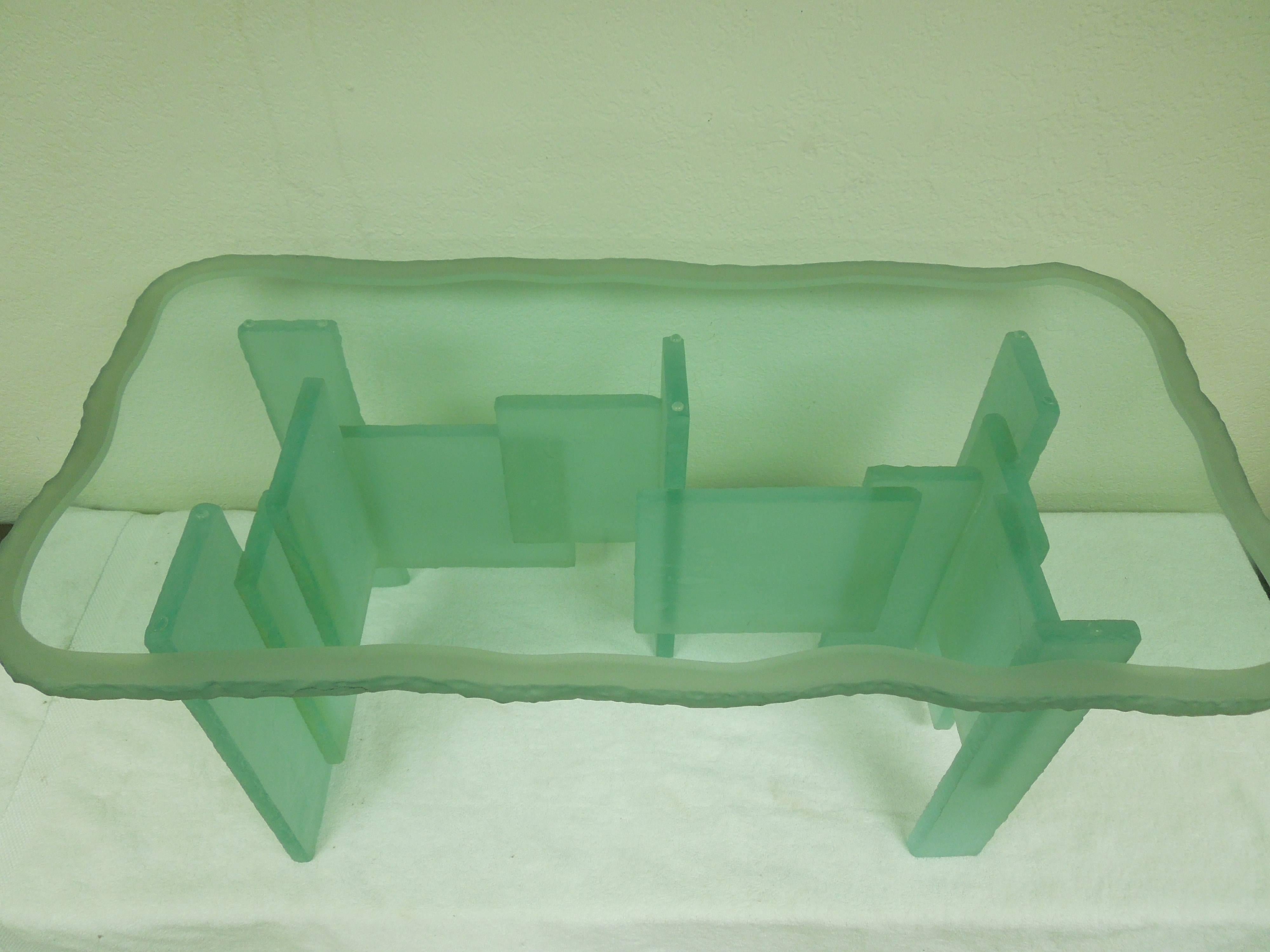 A signed art piece table in aqua glass. Cubist chisel edge rectangles form the base. Top is as amazing as the base with a chiseled with frosted stripe border. Signed L. Benjamin. Edition 1/91. All glass 3/4