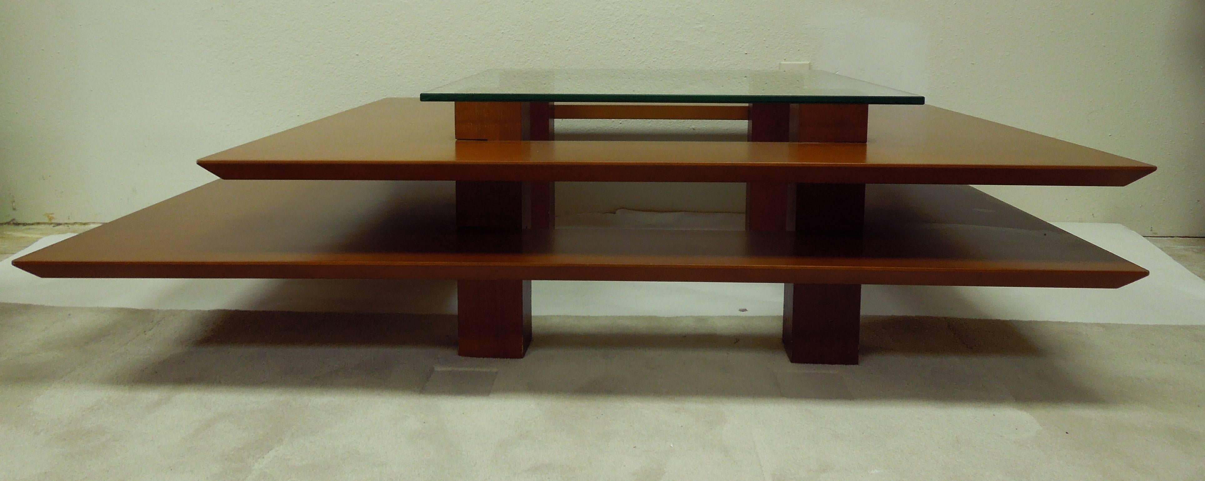 An architectural coffee table designed by French artist Clemmer Heidsieck. Purchased in nice, France. Combination of beech veneer and ashwood. Square glass tired top.