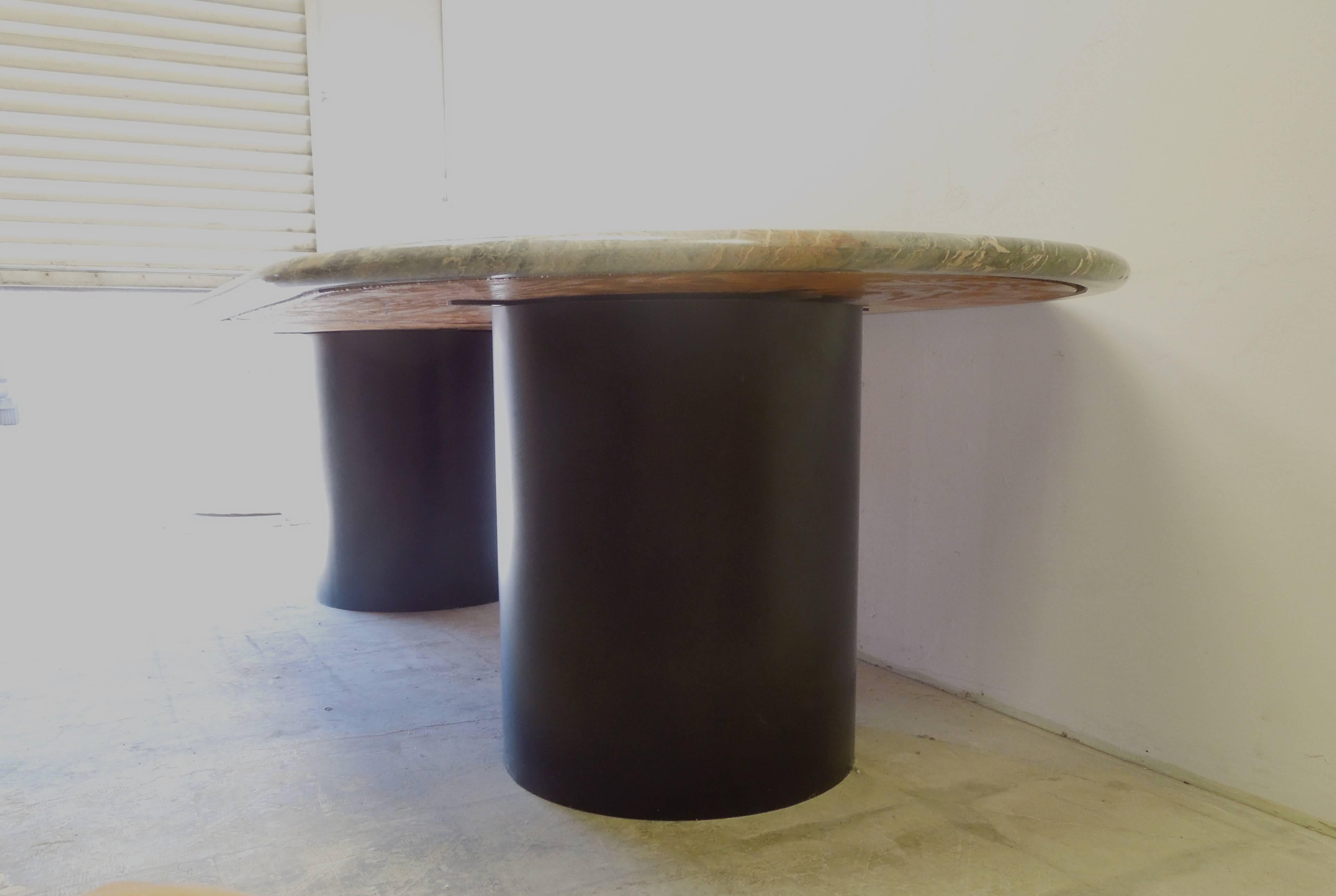 From a Hollywood Producer's Vintage Desert Estate, a custom made, racetrack shape dining table. The Italian marble table top in shades of grey, black, white and coral orange is from a 1960's massive one piece slab that is no longer available and