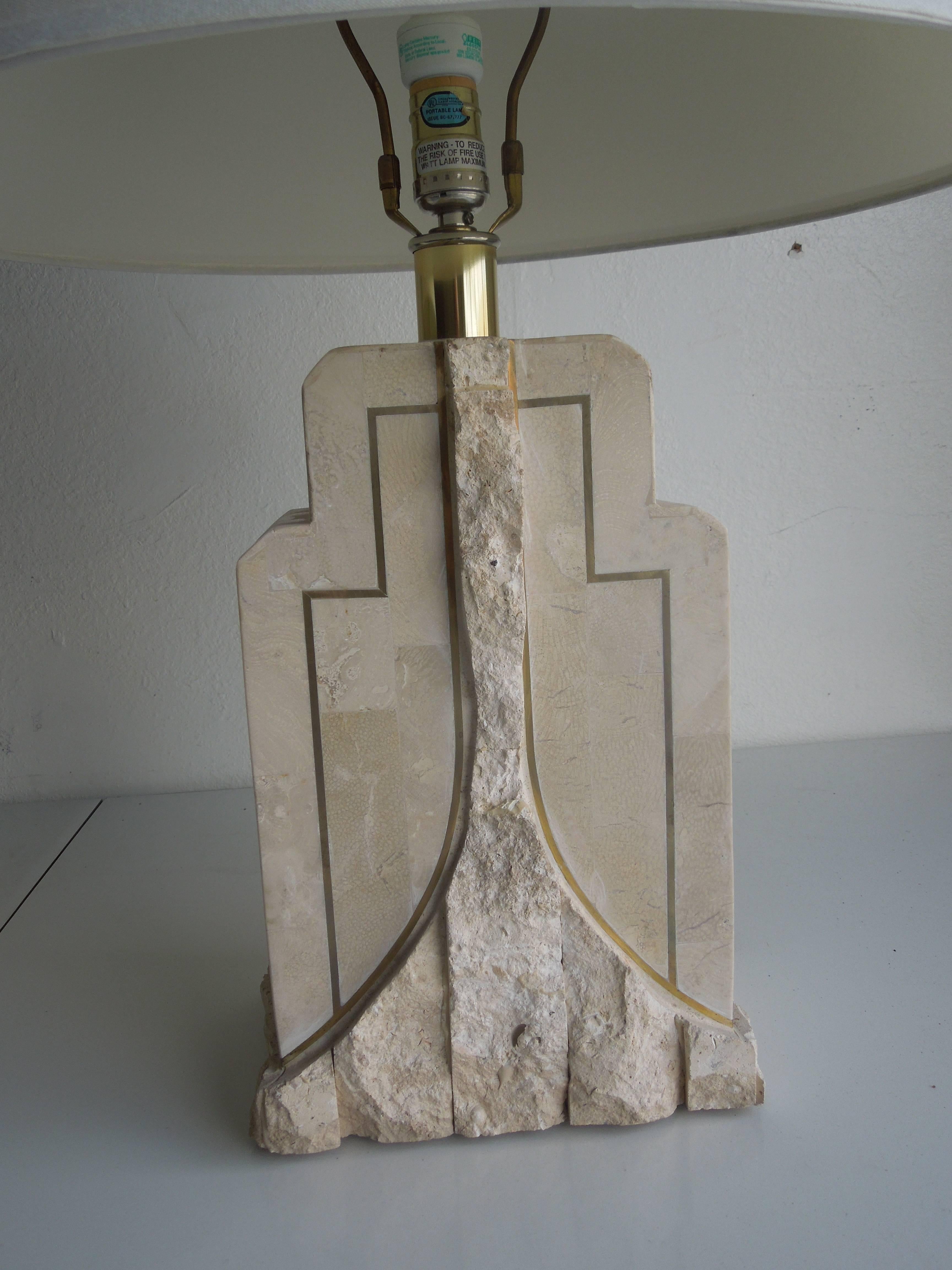 From a vintage Palm Springs residence (used in the master bedroom) a rare pair of chiseled rough and smooth tessellated stone lamps which obtain original shades. Lamps have beautiful brass trim. Lamps are finished on both sides, so can de used in a