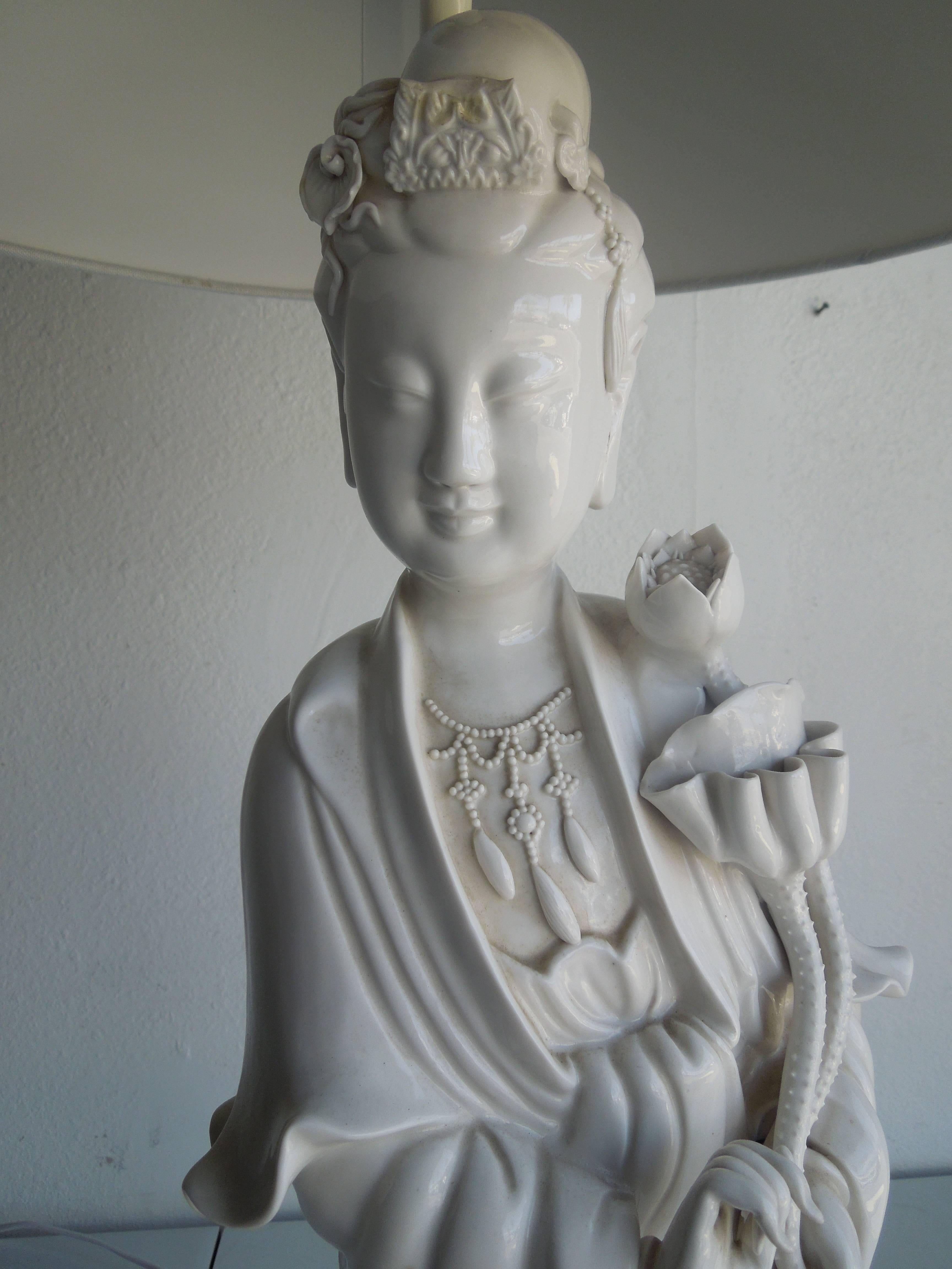 Newly rewired and new white linen shade is a stunning, large blanc de chine figural lamp of Quan Yin. The immaculate, opulence of the details of this piece is rare and done in the late 1940s-early 1950s. Finely sculpted fingers intact. Beautiful