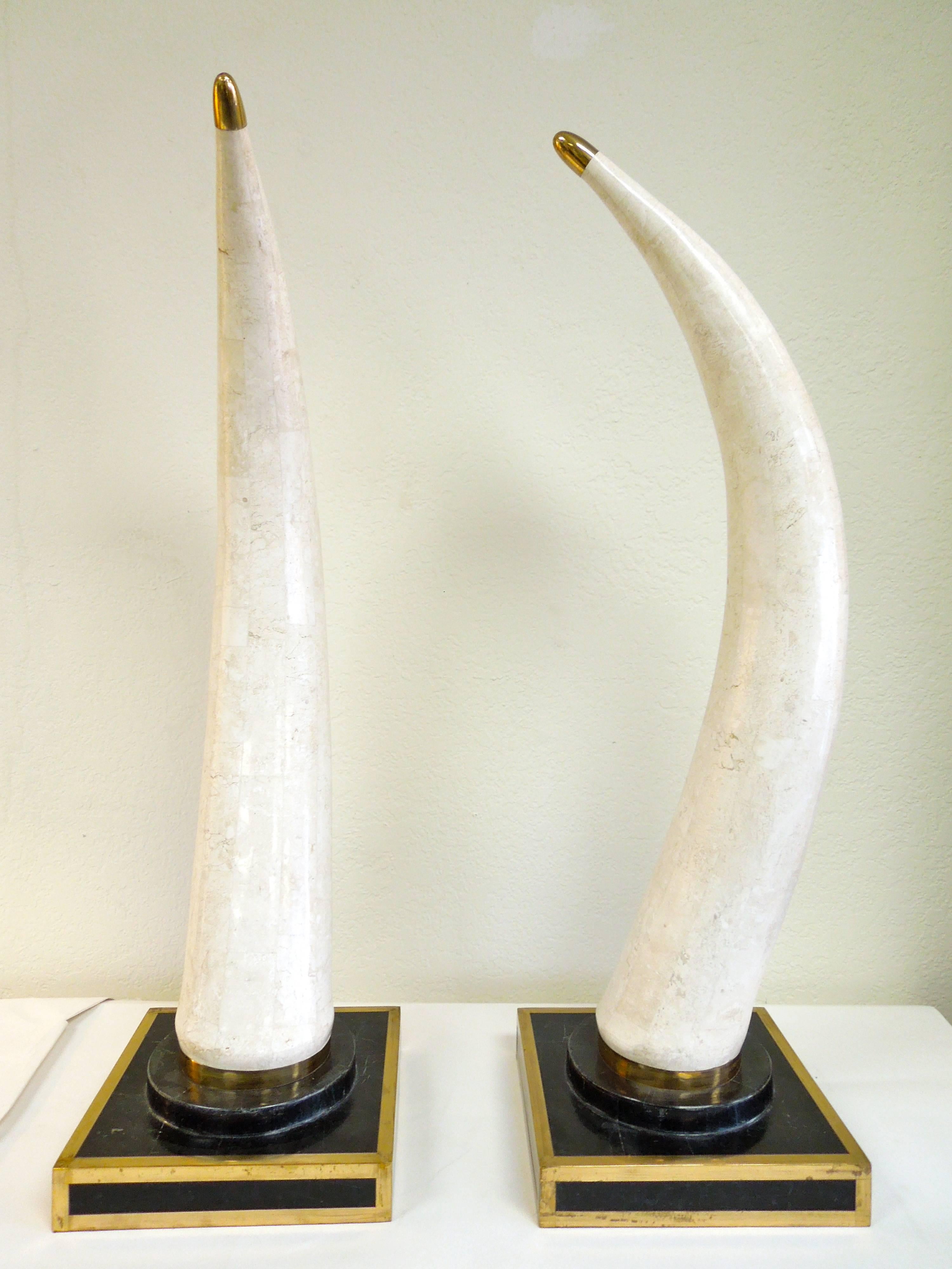 From the Palm Springs home of a retired Hollywood film producer are these very chic and glam pair of faux tusks made of tessellated stone and brass trim. Large, impressive 34'' height. Signed Marquis Beverly Hills.