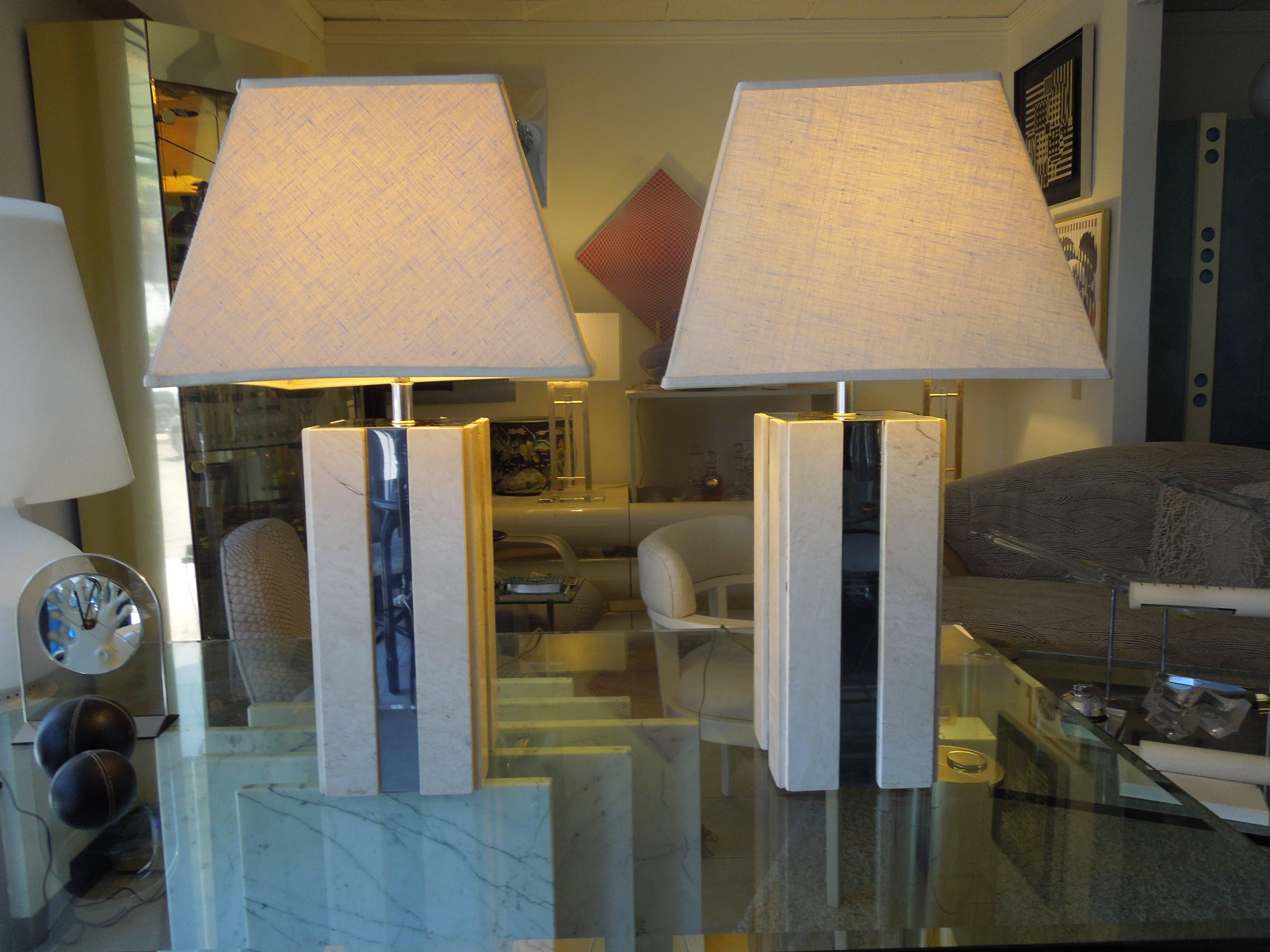 From a beautiful professionally designed Palm Springs estate, with gorgeous designer 1970s furniture and art, are these pair of travertine and chrome skyscraper lamps. They obtain original square tent shape shade. Takes normal three way bulbs.