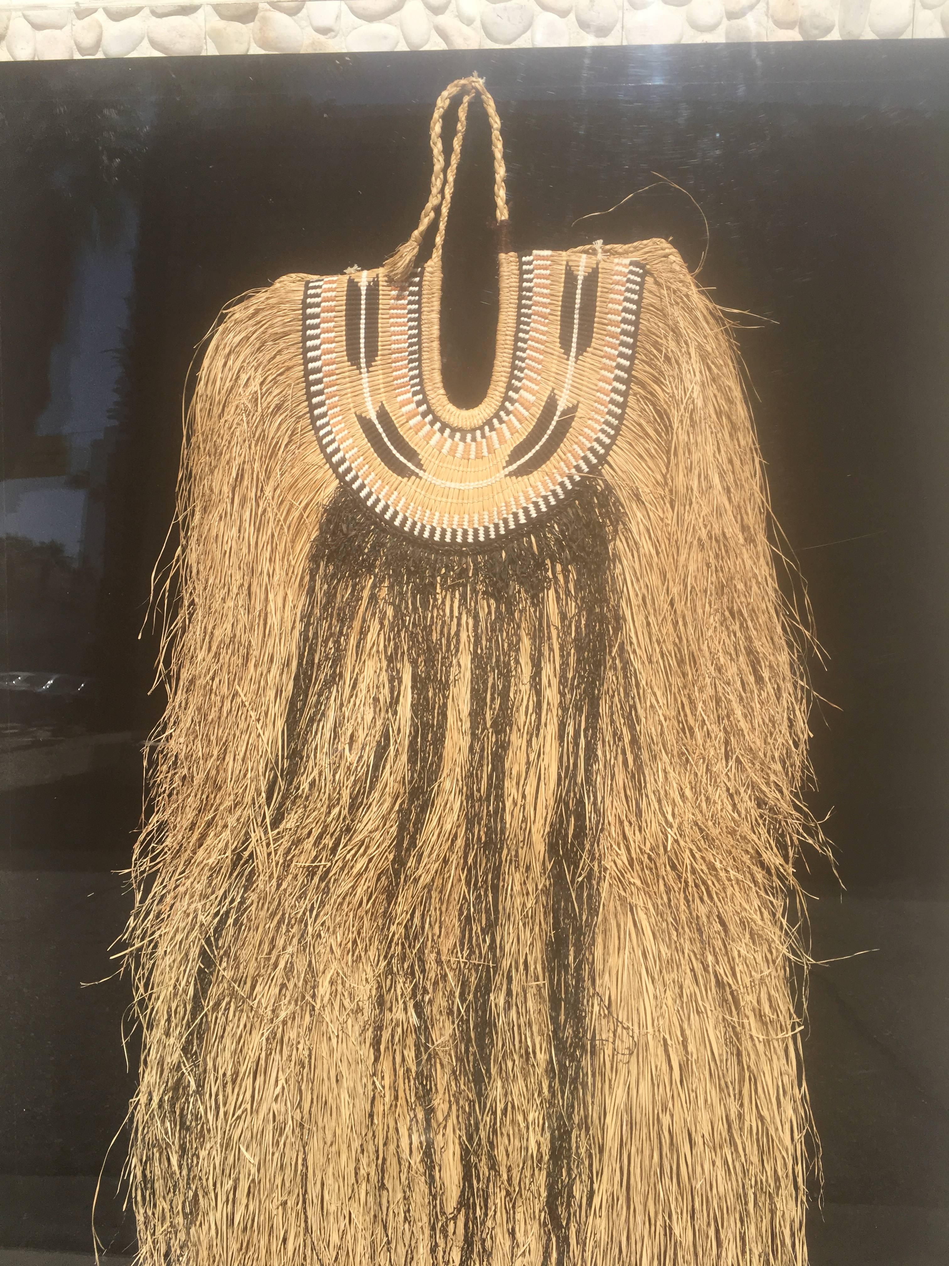 It is a gorgeous straw handwoven vintage African neckpiece / costume from a prestigious Estate in Palm Springs entirely designed by the late, great, interior designer Steve Chase. Beautiful Plexiglass case with black background.