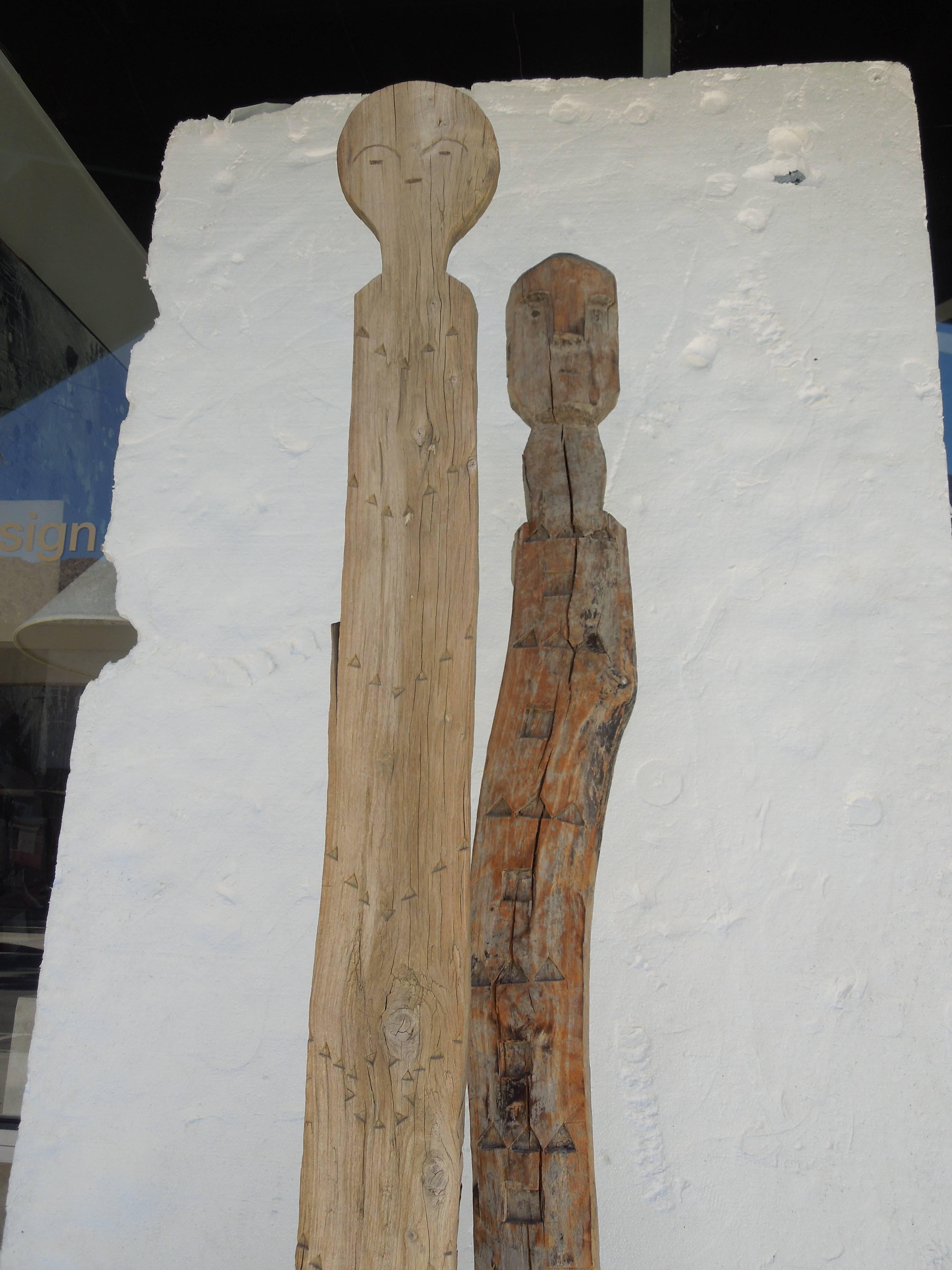From a prestigious Palm Springs Estate, a rare pair of hand carved African figures on custom iron bases. 