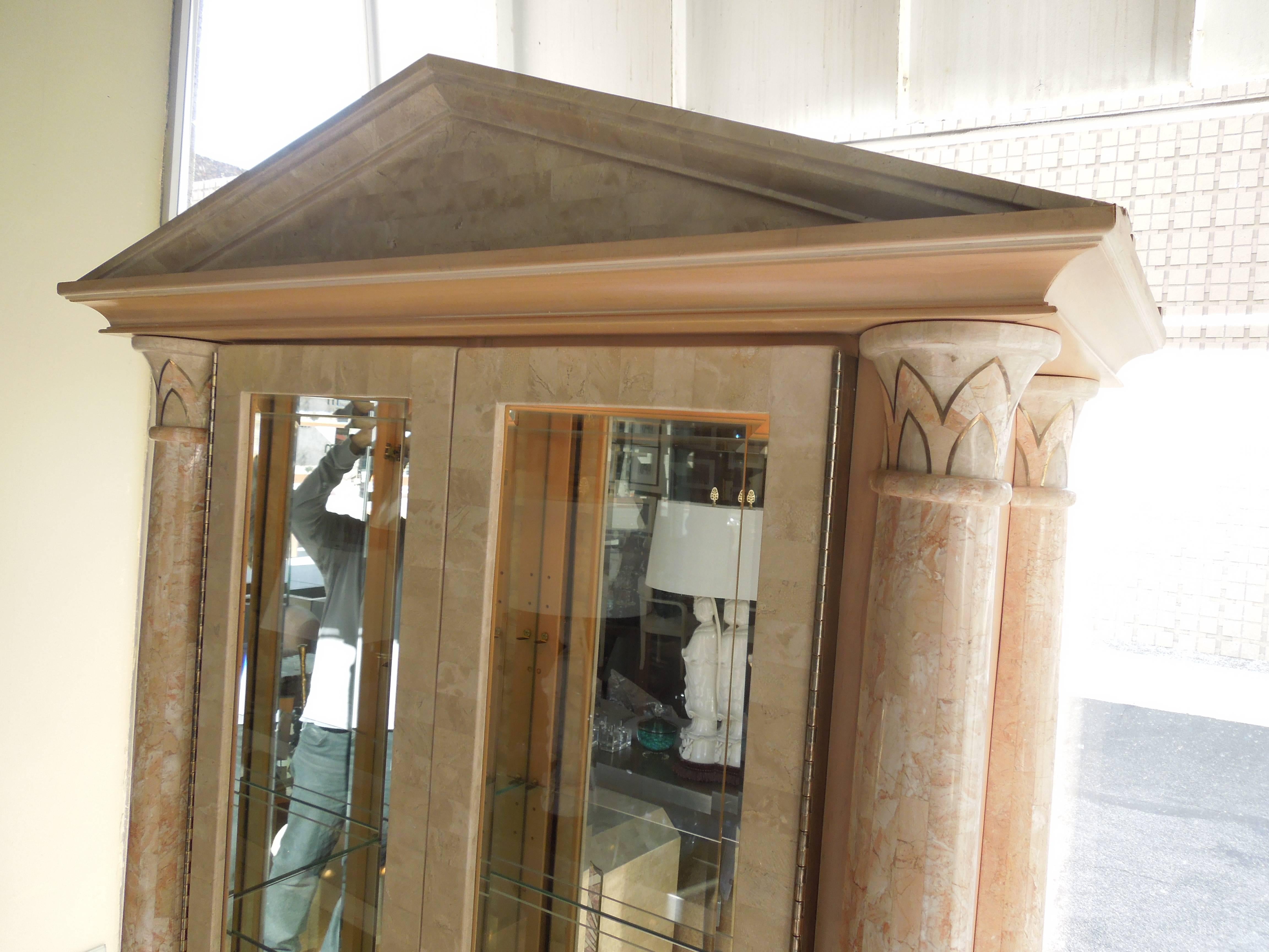 This cabinet was custom made for a client's major Palm Springs estate. The attention to detail and quality on this cabinet is unbelievable. Inlaid coral color tessellated stone with brass trim. Wood sides and base. The columns are Meoclassical with