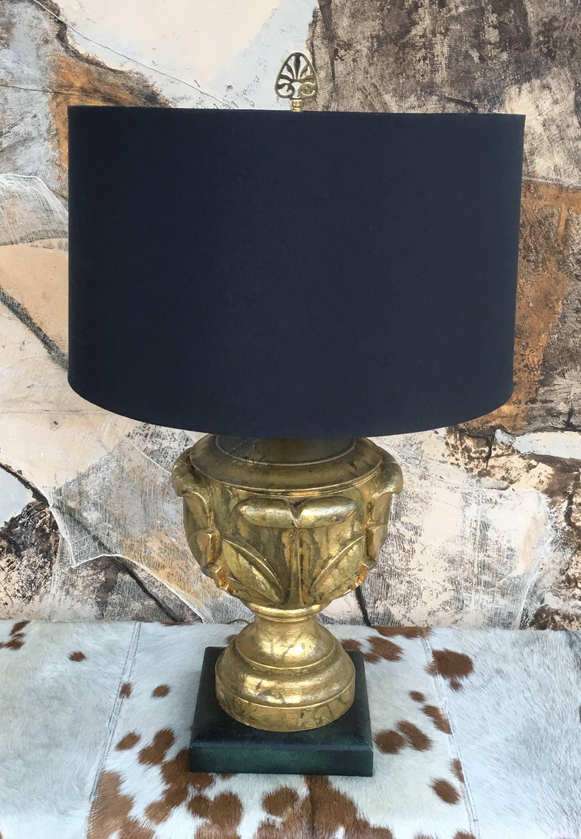 An extremely chic lamp from a very upscale home in Palm Springs, CA done entirely in high end Hollywood Regency. The lamp is a combination of brass, Hand gold leafed wood and faux finish base. The original shade is perfect form and color to
