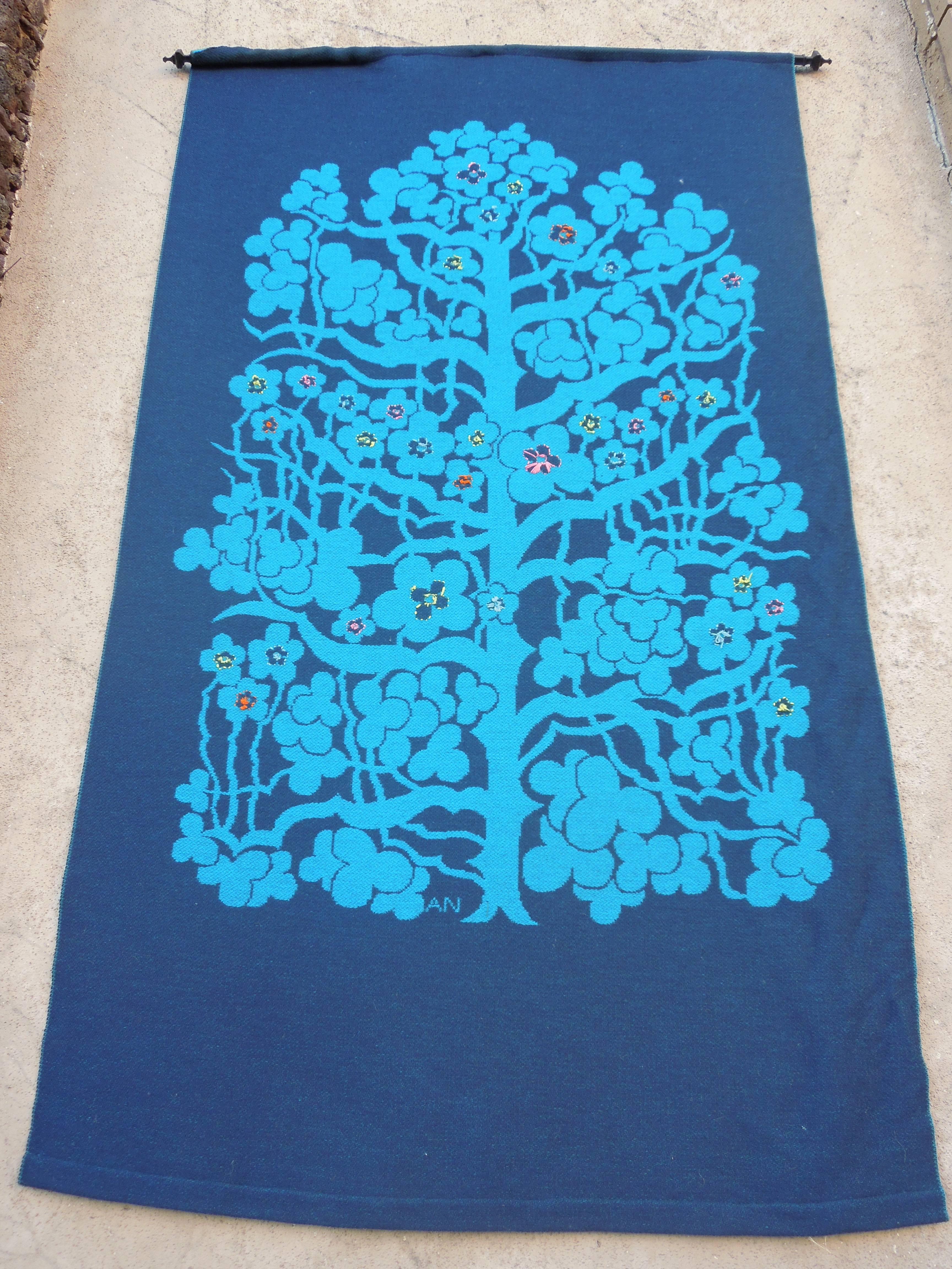 This large beautifully handmade blue colored wool tapestry is from a very upscale Palm Springs estate. The tapestry is signed AN. The tapestry is double sided, and was hung on the reverse lighter side, instead of the true face which is the navy