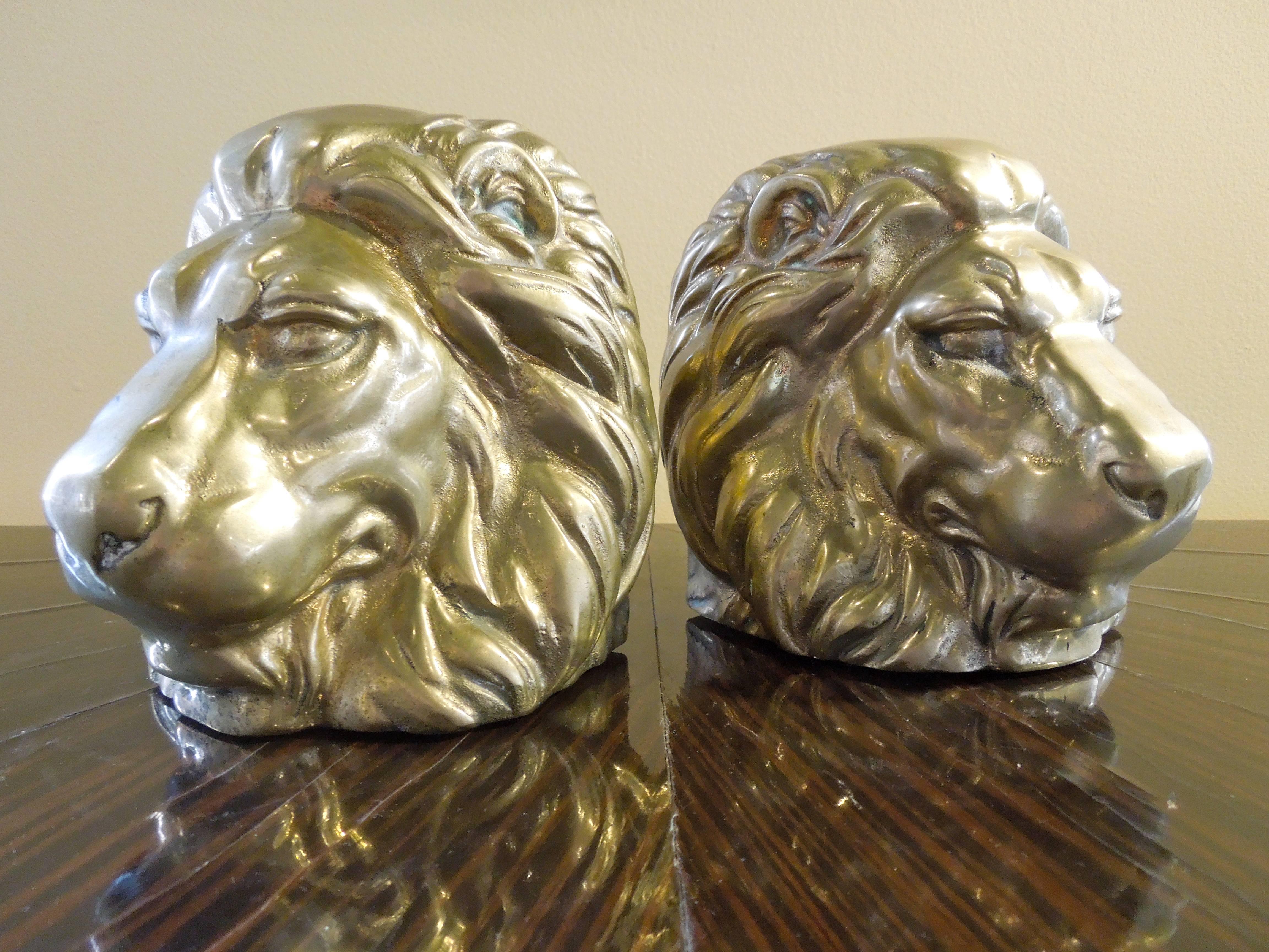 A very beautiful pair of bookends made of solid brass with the amazing detail of a lion's head. From a very upscale vintage Palm Springs estate.