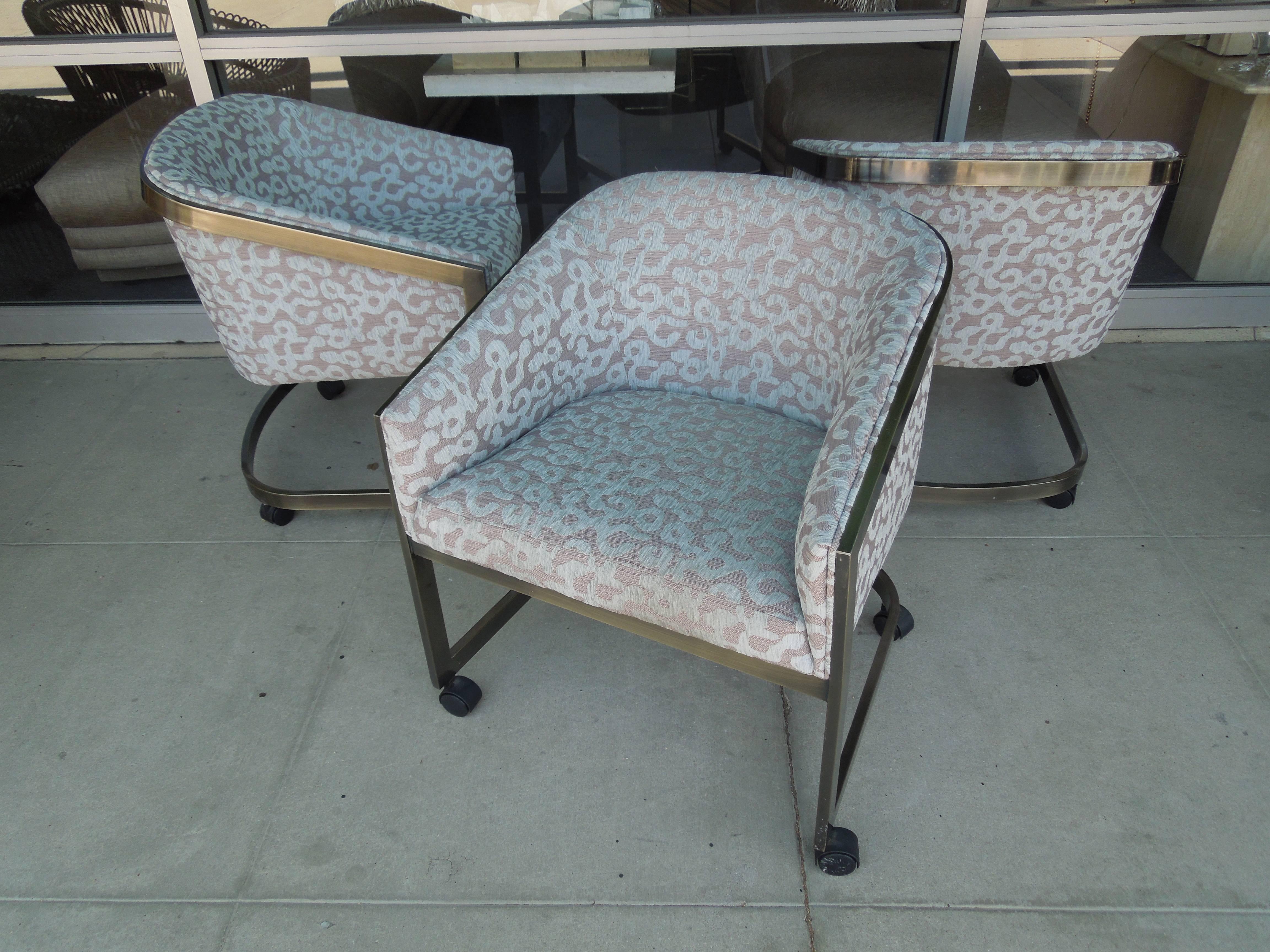 A super chic set of three bronze finish bucket chairs on casters made by Design Institute of America. From a very chic vintage Palm Springs Estate, the chairs have been newly upholstered in a high end European jacquard in modern grafitti pattern.
