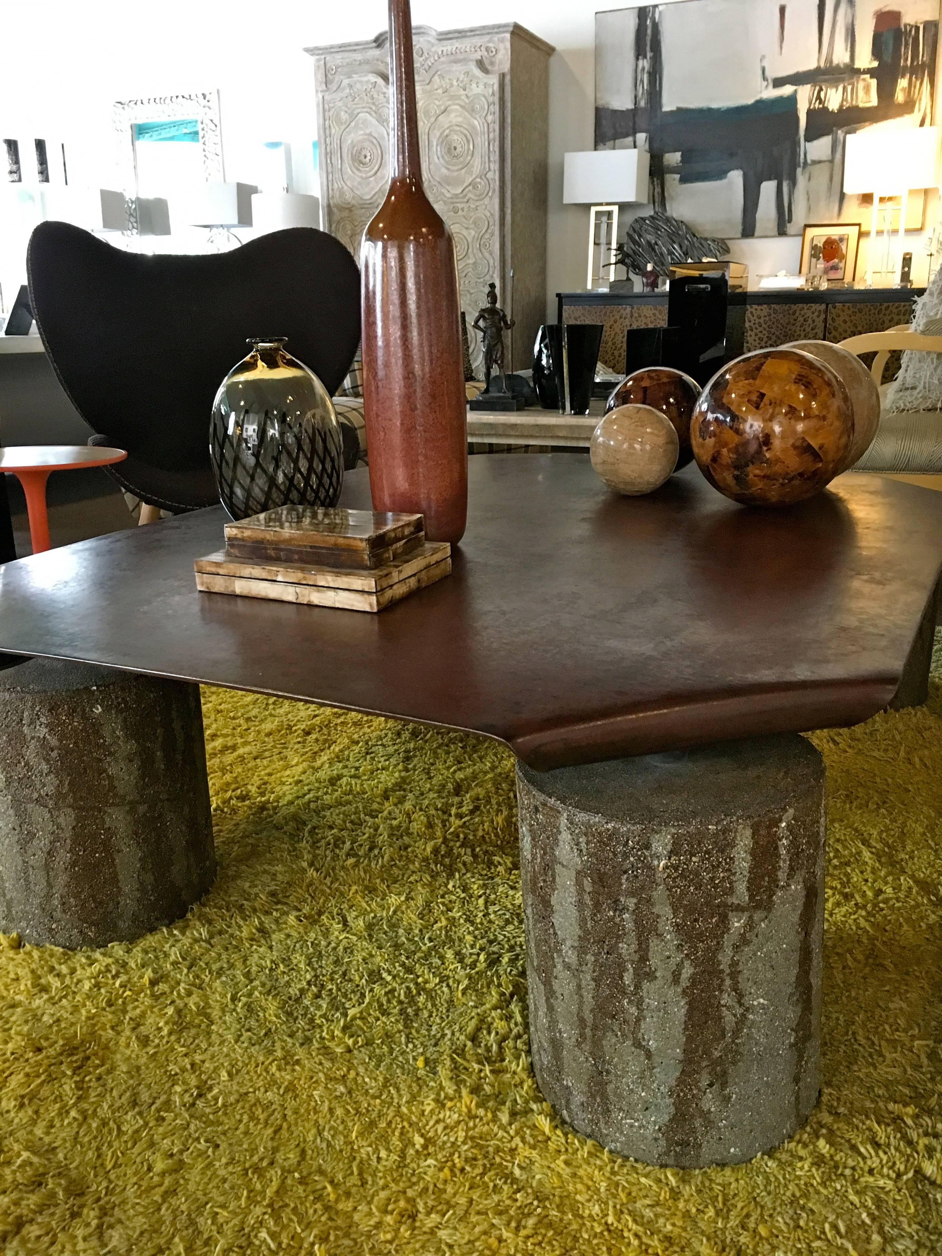 This amazing piece of art as a coffee table was custom-made by designer Jeffrey Jurasky for a prominent Palm Springs family's residence. The label reflects this. Made of beautifully patinaed rust color iron with colored concrete cylinders as feet.