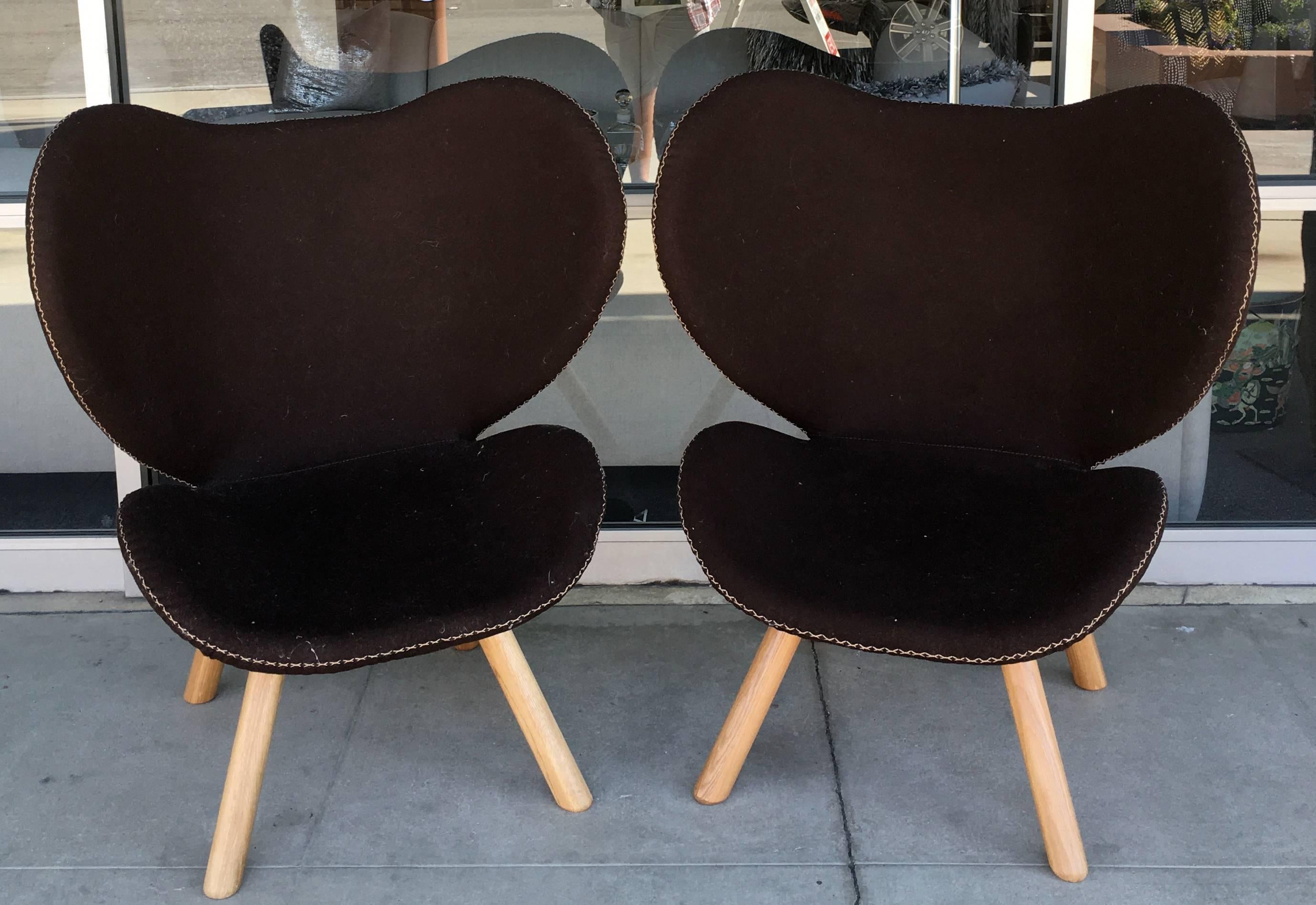 These chairs were Mid-Century designed in Denmark, but made recently on awesome dark brown wool with hand stitching detail. Great solid wood legs. The chairs have an amazing back design and look great from all angels. Danish design plaque on each