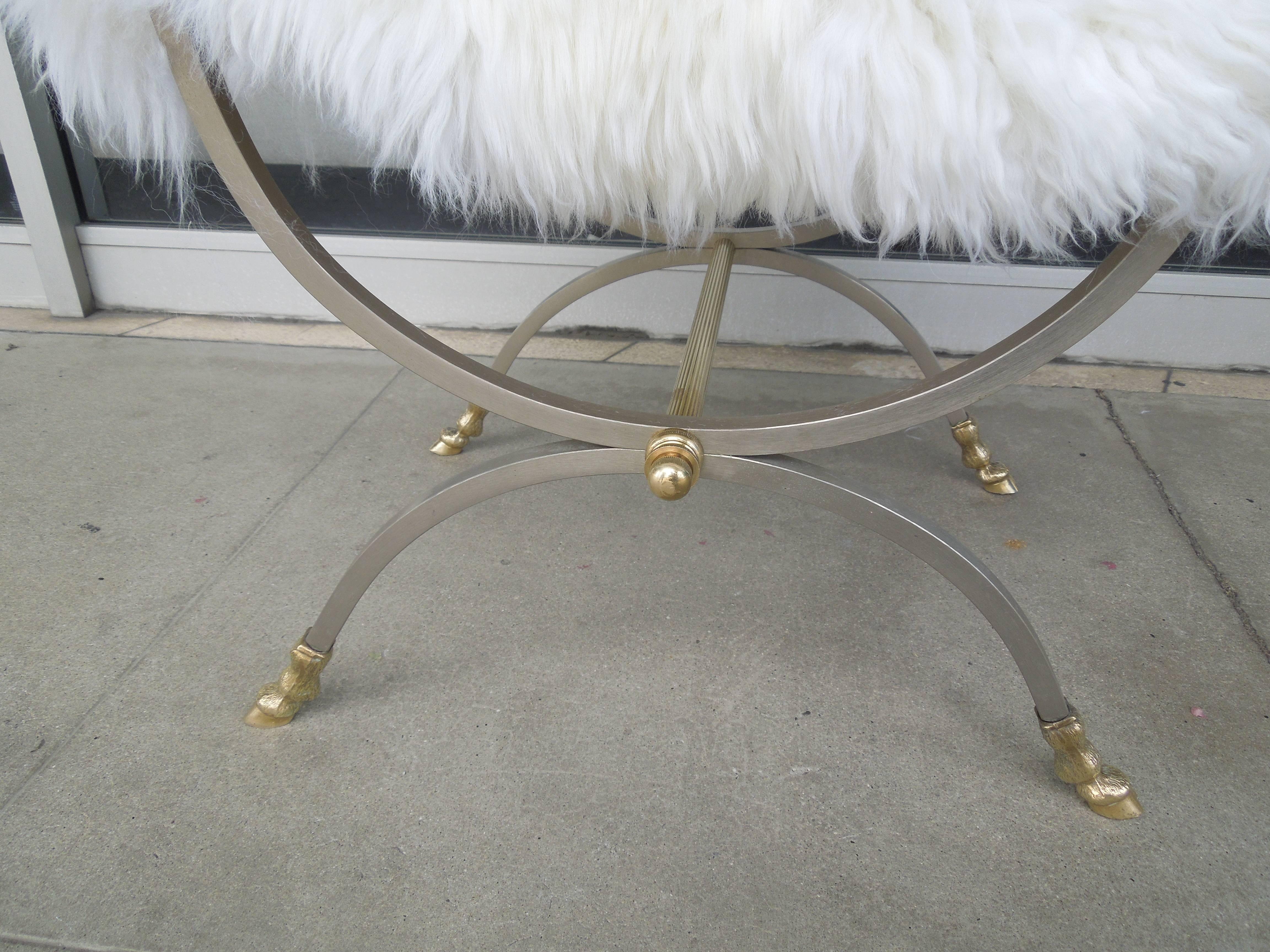A very chic French Directoire style bench very much in the style of Jansen. From an Architecturally significant Palm Springs Estate. Made in Italy, in nickel and brass, the bench obtains original thick white leather seat. Have added a new off-white