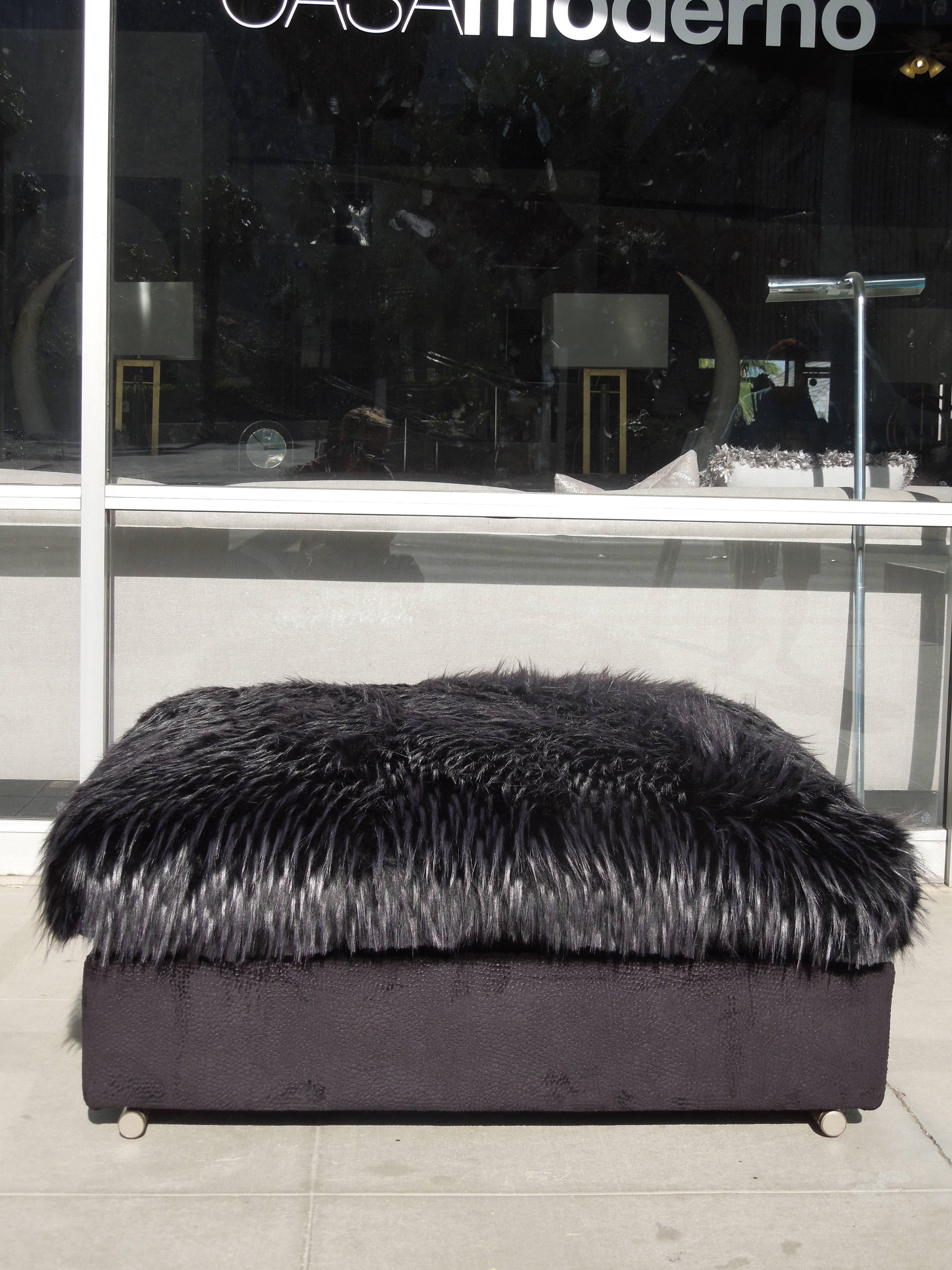 A very chic and modern Italian ottoman newly upholstered (in California) in a textured faux suede jacquard base with a very high end European faux fur top cushion. The ottoman bases are modern silver nickel rods that are visible front and back. The