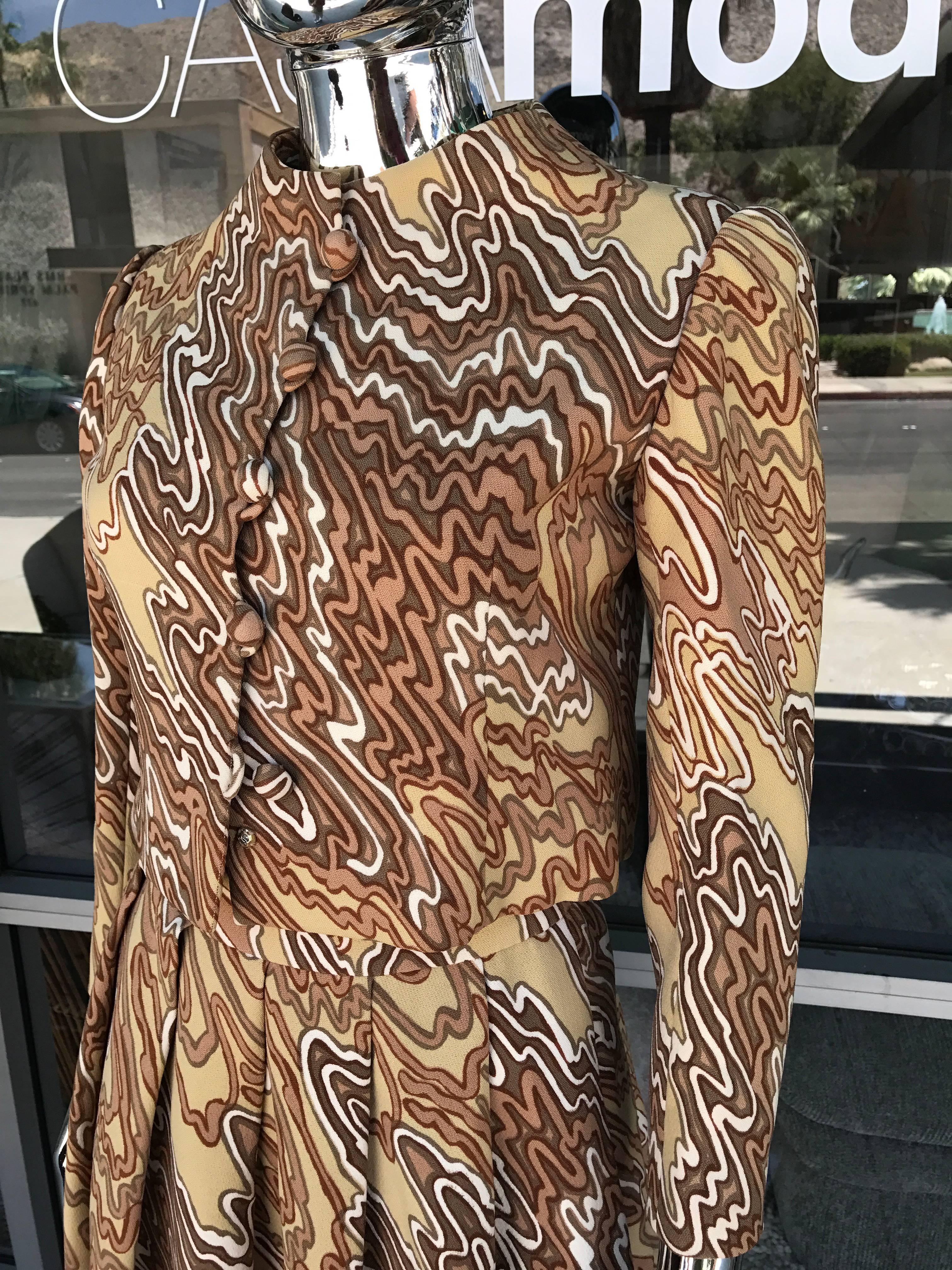 A really beautiful three-piece suit by legendary designer Arnold Scassi. Couture Jacket, skirt and blouse made by hand in NYC. The print is a very modern 1970s wool blend and blouse is coordinating print in silk. All pieces marked Arnold Scassi. I