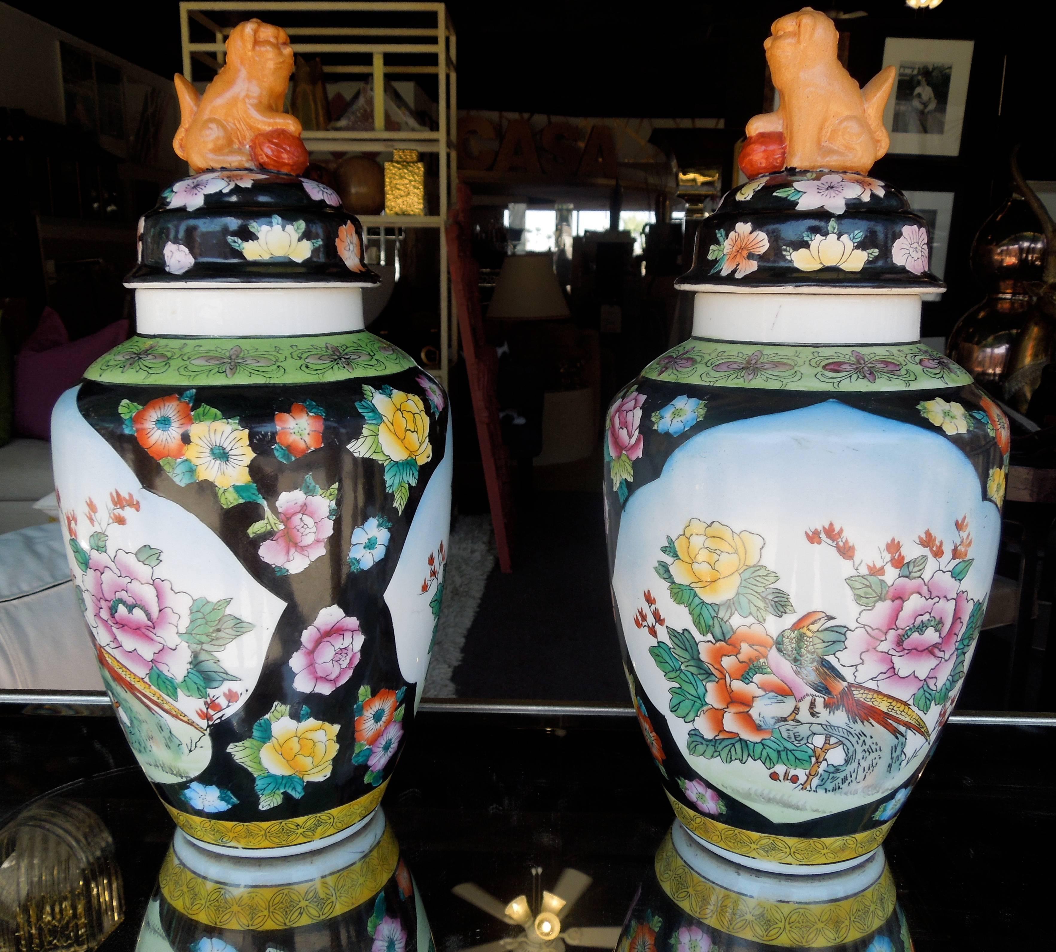From a very upscale Palm Springs Estate, these charming pair of Chinese ginger jars have wonderful floral and bird motif bases with lovely foo dog tops. Beautiful colorations. No chips at all. In excellent condition.