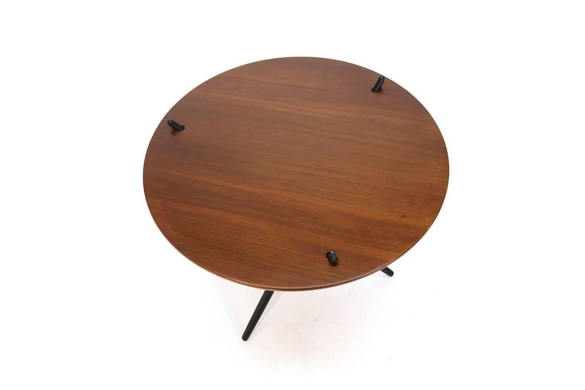Desgned in 1946 by Hans Bellmann for Knoll and produced between 1948 and 1961. The Model 103 tripod table is a study in simplicity. This example features a walnut top and black lacquered legs. It retains remnants of the original Knoll label on the