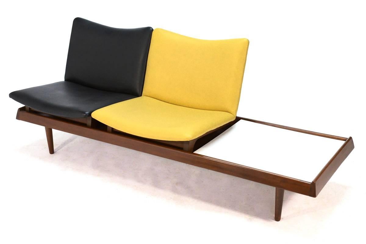 Very cool modular seating group designed by Gerald McCabe in the 1950s. The platform allows multiple configurations of the two seats and the white laminate table top so it can best suit your space and seating needs. This piece is all original and