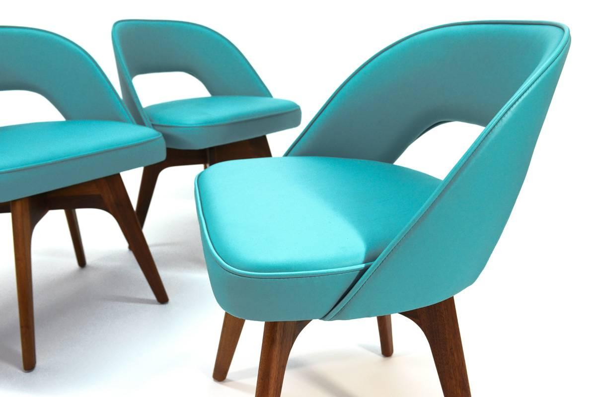 Very fun set of four swivel dining chairs designed by Chet Beardsley for Living Designs. The sculptural walnut bases are reminiscent of some Adrian Pearsall designs. The new teal vinyl upholstery would add a fun pop of color to any space. They