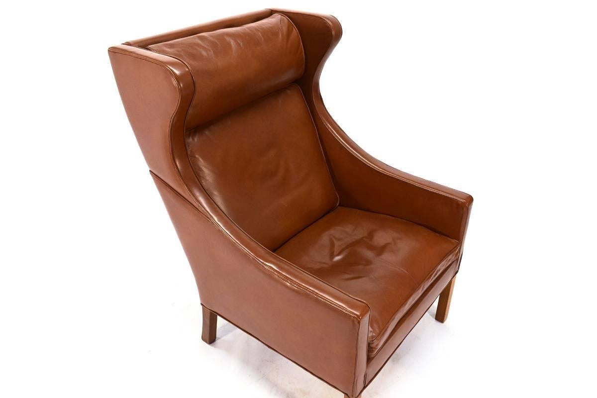 Fantastic leather wingback designed by Børge Mogensen in 1963 for Fredericia Stolefabrik of Denmark. This is model number 2204. This piece is all original and in excellent condition. Retains the original Danish control tag. Seat height is