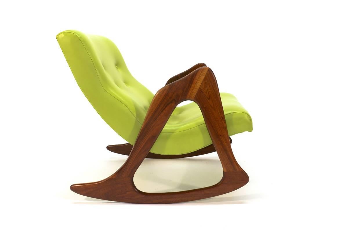 Stunning sculptural rocking chair designed by Adrian Pearsall for Craft Associates. The crescent shaped seat was reupholstered by a previous owner in a lime green vinyl, very fun, but easy to change if it doesn't suit your taste. The sculptural