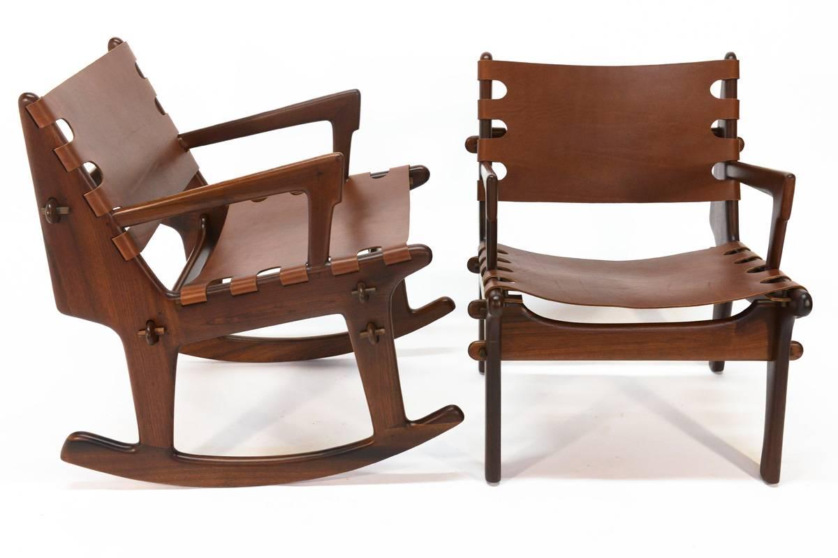 Beautiful pair of chairs by Angel Isaac Pazmino for Muebles de Estillo of Ecuador. These feature solid rosewood frames with leather slings. The frames are are held together entirely with pegs, so they can be broken down and re assembled easily.
