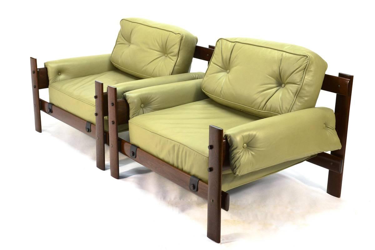 Fantastic pair of lounge chairs designed by Percival Lafer with exotic hard wood frames and leather upholstery. These have very nice proportions with a wide seating area and low back. The plank construction is almost dramatic in its simplicity.