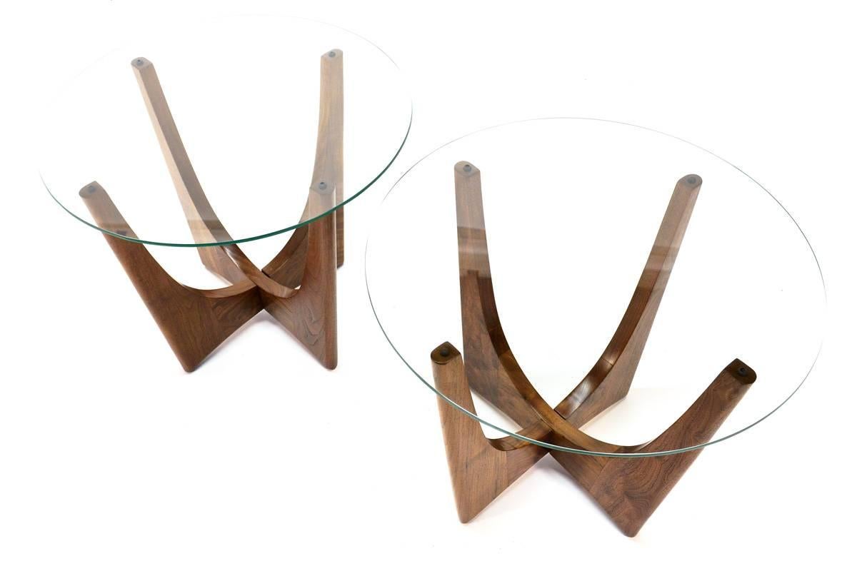 Beautiful sculptural walnut side tables by Adrian Pearsall for Craft Associates. The color and grain of the walnut on these pieces is truly fantastic. The round glass tops are brand new.

Measures: 24