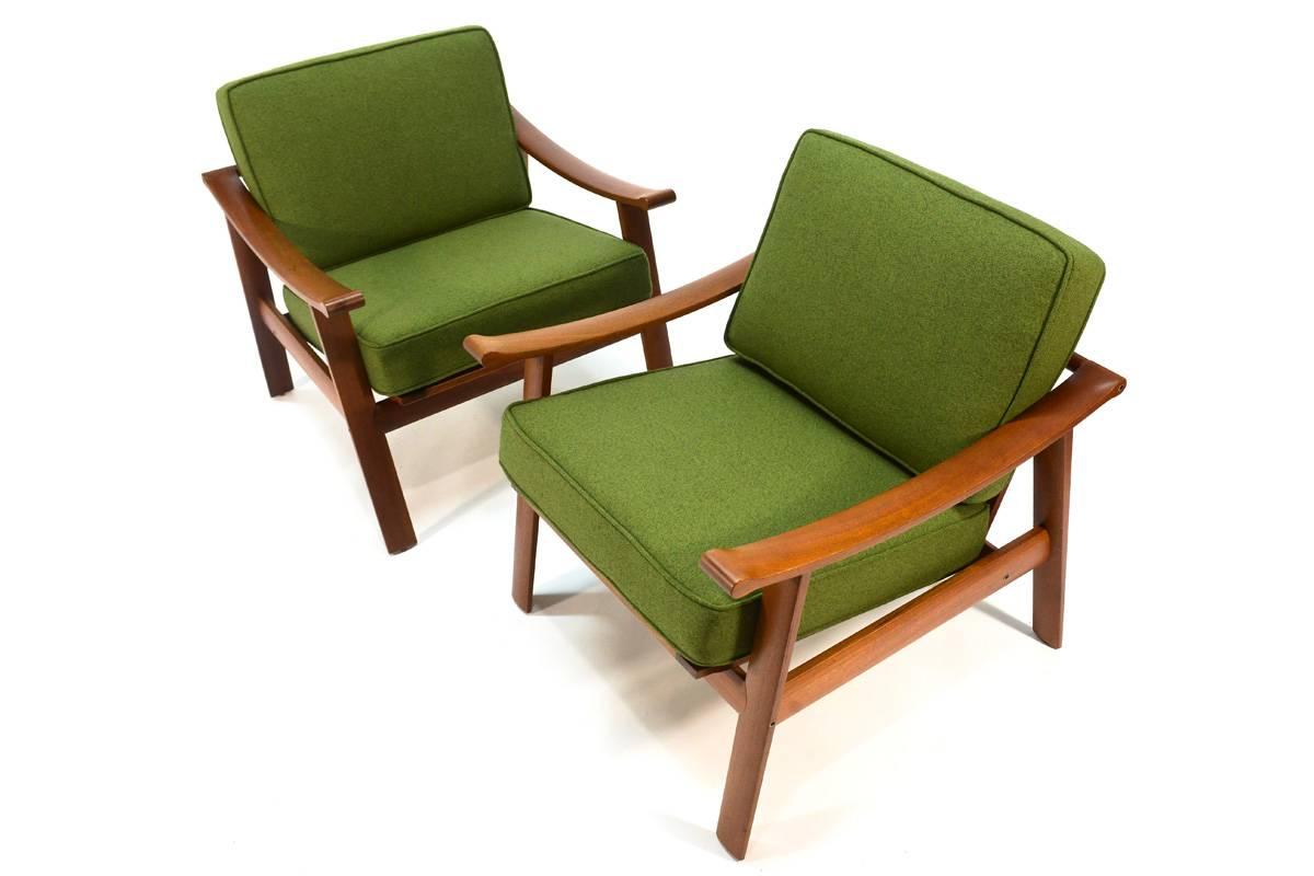 Beautiful pair of Danish teak lounge chairs designed by William Watting. These rarely show up, particularly in pairs. The design is simple yet refined with gently curving armrests terminating in rounded details on the front and back. The cushions
