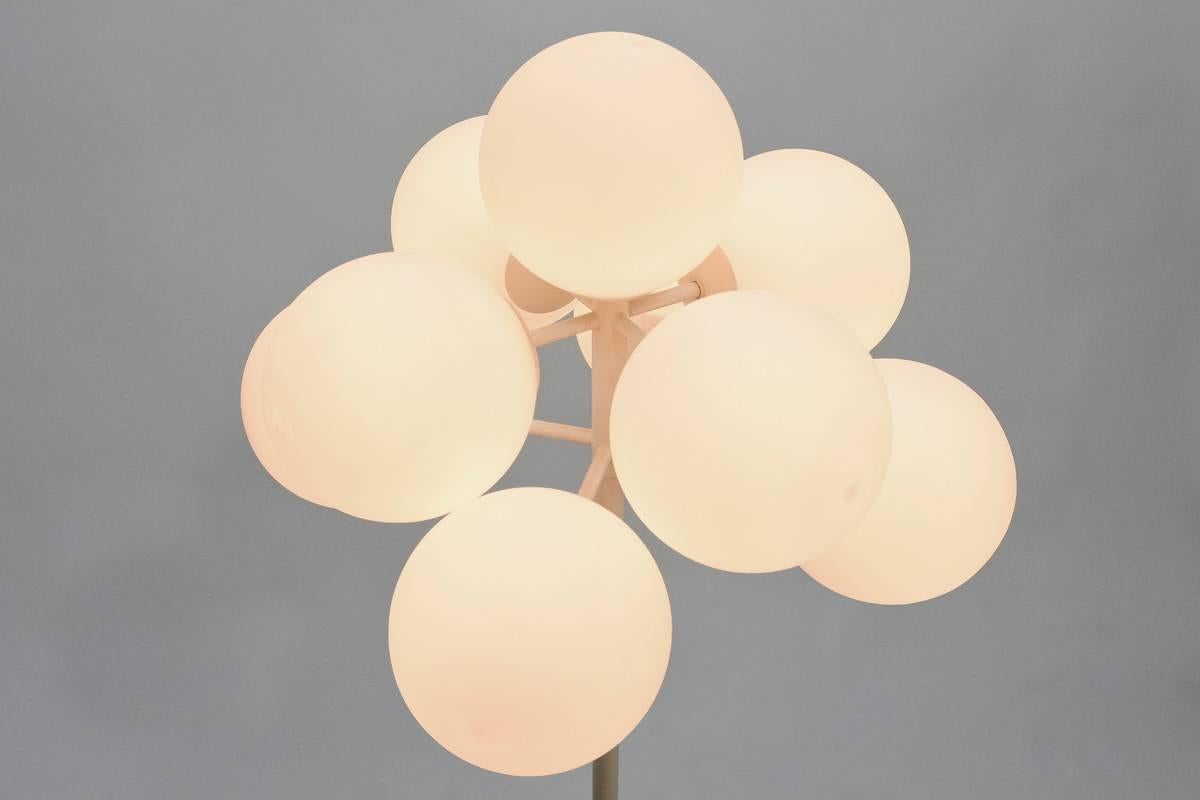 A beautiful floor lamp that is often attributed to Max Bill, but was actually produced by German-Swiss lighting manufacturer Temde Leuchten. Features nine frosted globes that screw on to stay securely in place. This lamp has been completely rewired.