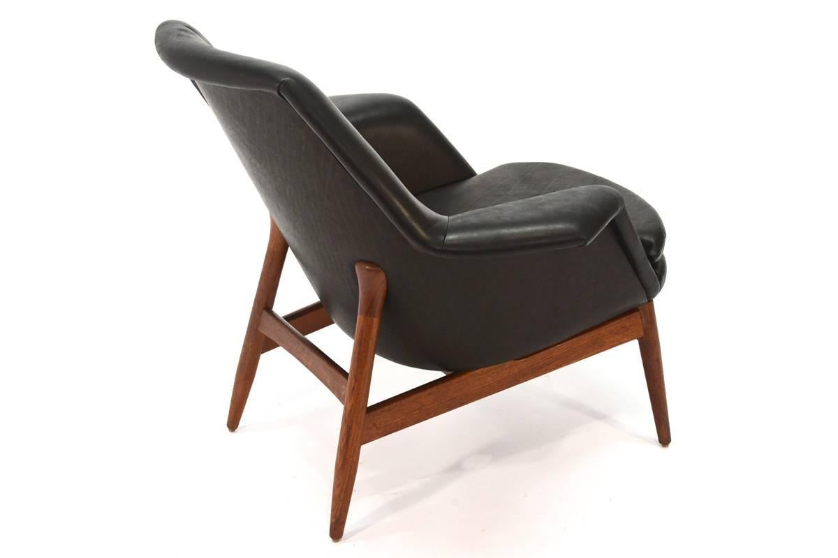 Rare piece designed by Björn Engö for Möre Stolfabrik in Norway and imported by DUX. This chair is beautiful from every angle. It gets the Manta Ray name from its wide pointed arms. It has been recovered in super soft black leather that contrasts