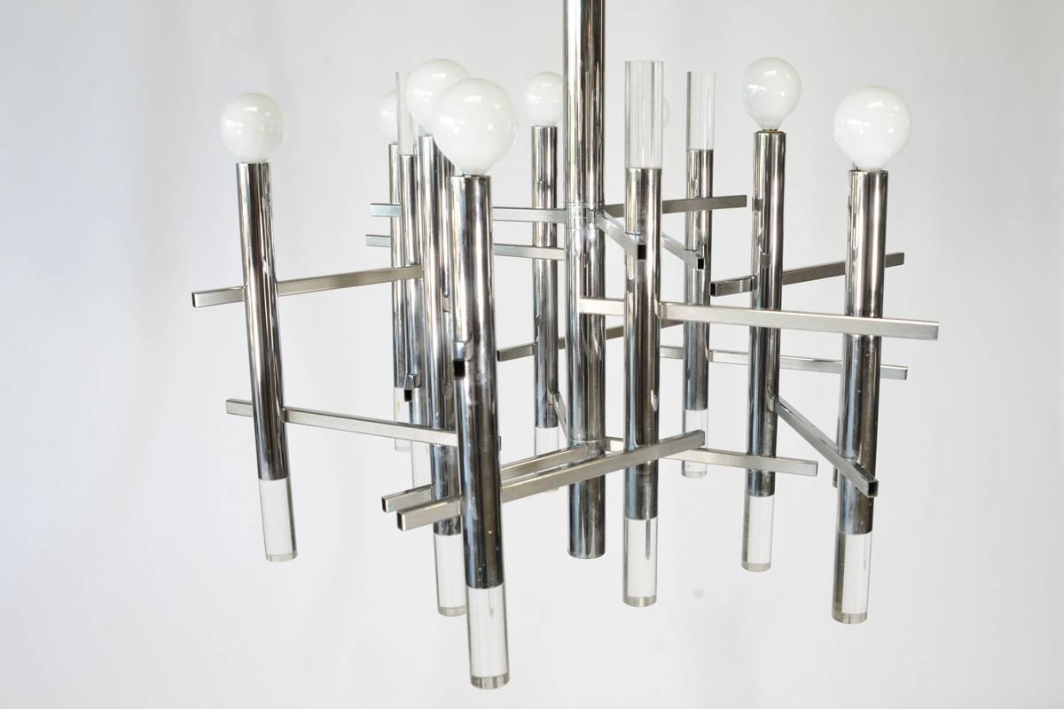 1970s chrome and Lucite chandelier by Gaetano Sciolari. In very nice original condition, with light signs of age and use. Retains the original label on the inside of the ceiling plate. Measures: 25