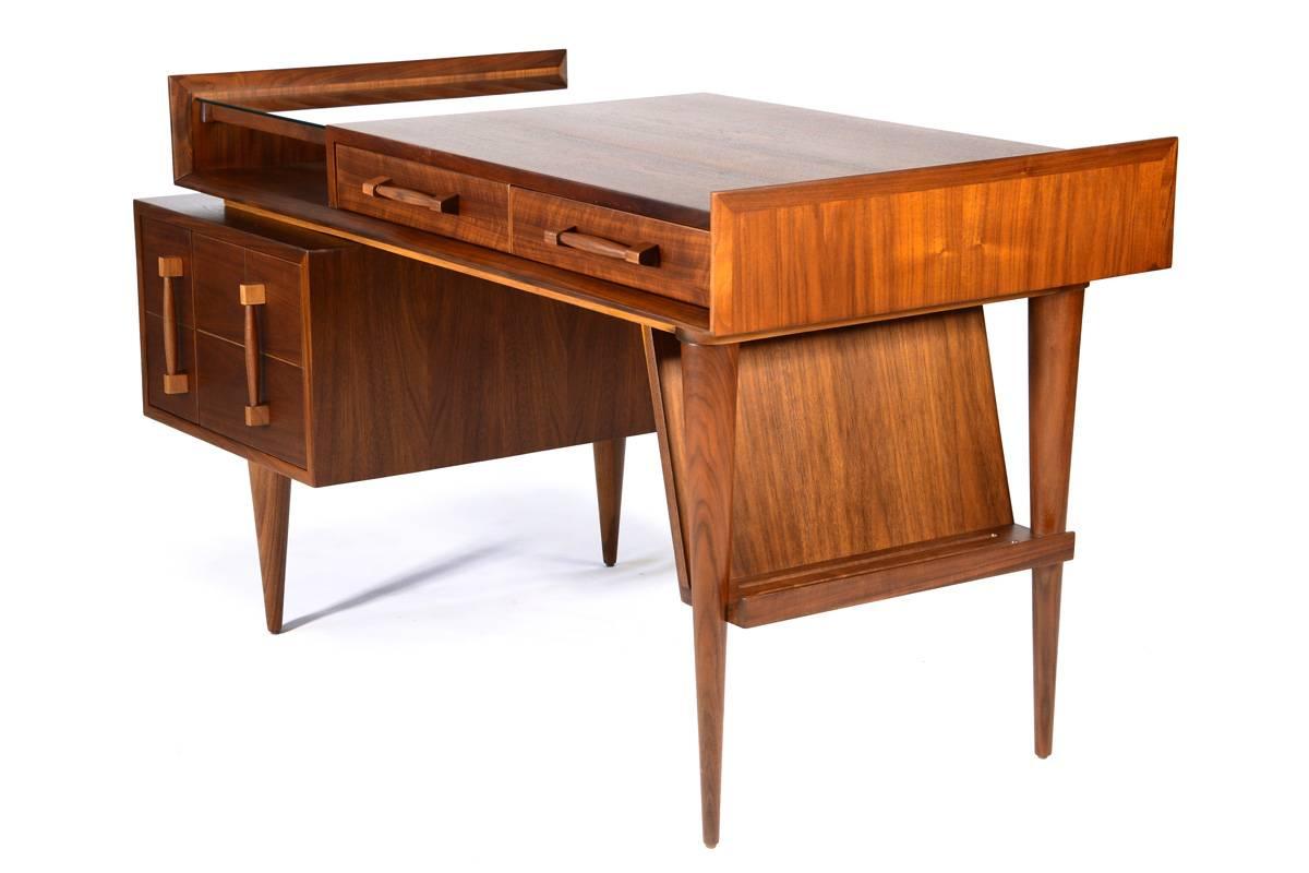 This piece is spectacular, an absolutely beautiful desk. Produced by Sherman Bertram in the early 1950s. These pieces are quite rare, particularly in walnut most Sherman Bertram pieces from this line are mahogany. The styling on every piece of this