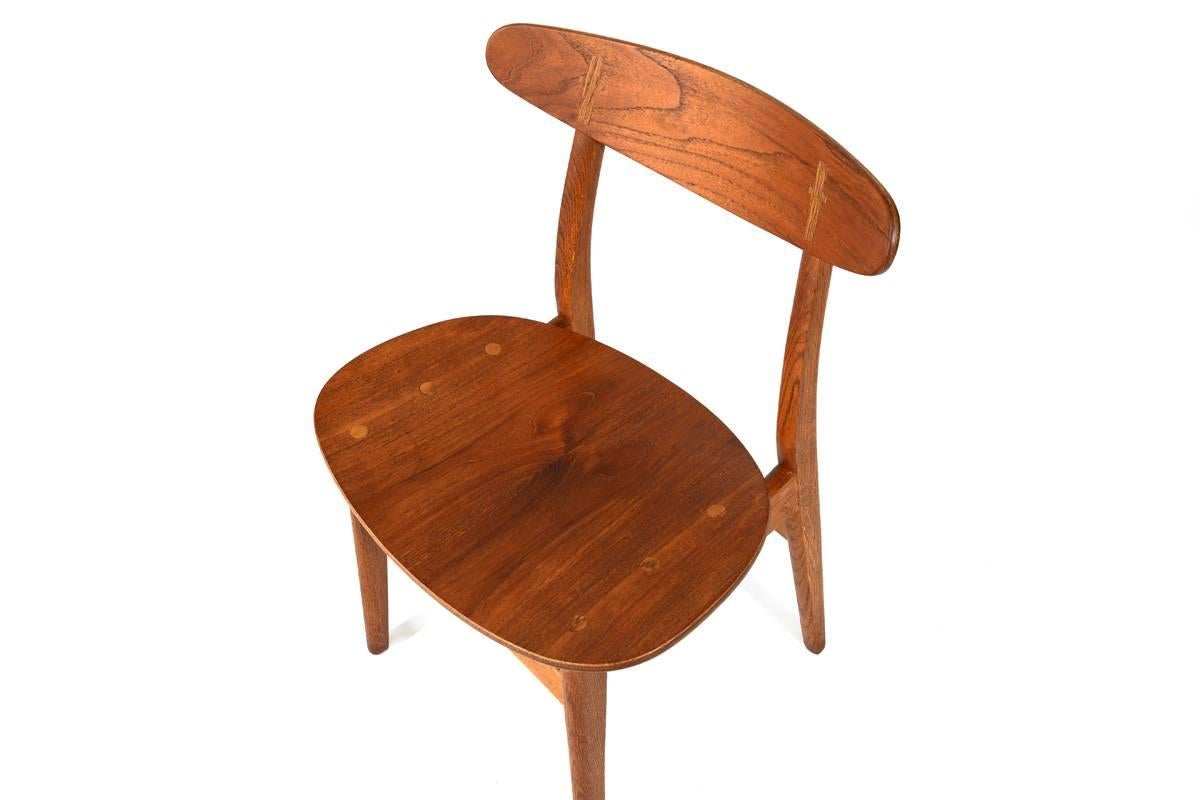 Beautiful Hans Wegner “CH-30” dining or desk chair. Designed in 1952 and Produced by Carl Hansen & Son in Denmark. With its teak back and seat paired with the oak frame, this is the most desirable variation of this chair. Great detailing with the