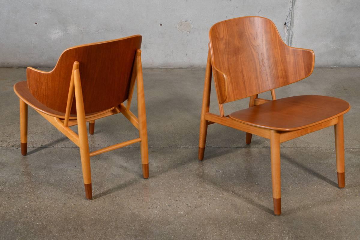 A rare pair of shell chairs designed by Kofod Larsen with bent teak seats and backrests and two tone wood frames. This iconic mid-century design is as comfortable as it is beautiful. This version of this chair, in all wood, is much less common than