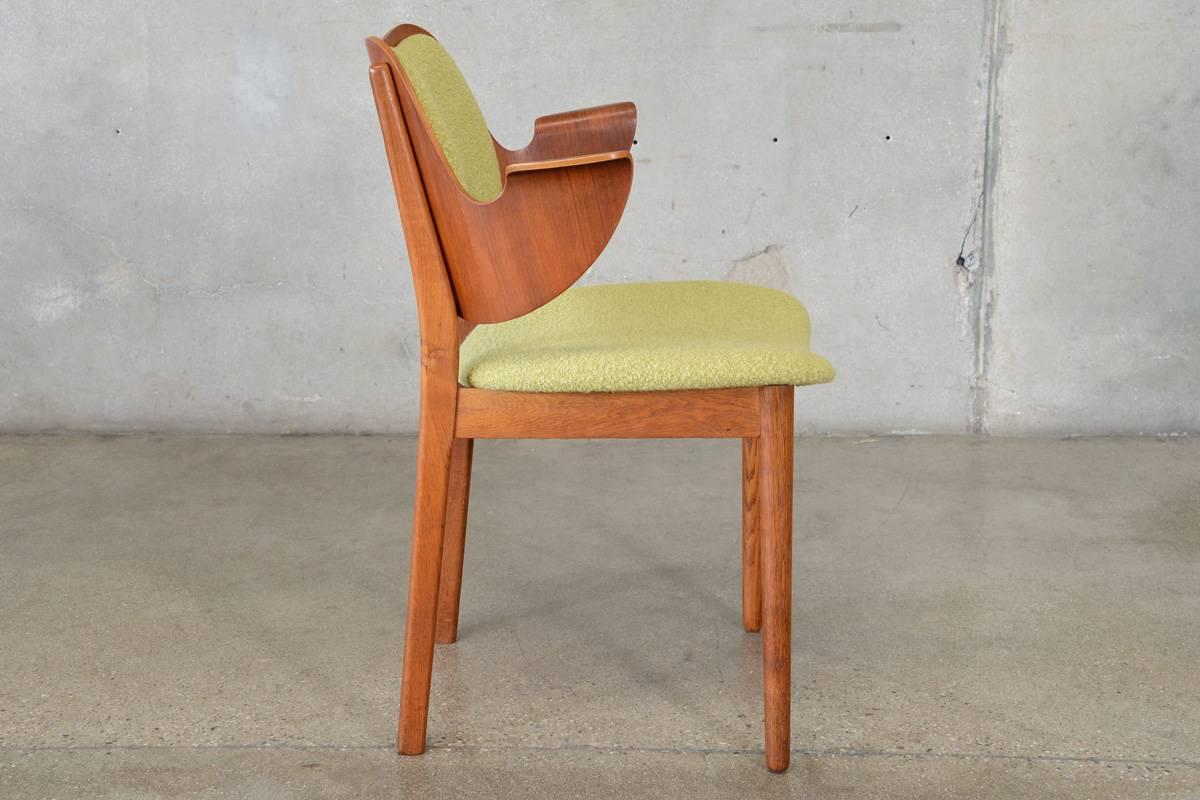 Designed by Hans Olsen for Bramin Mobler in 1957 this armchair features a curved teak backrest with a solid oak frame. This is the taller version intend to be used as a desk or dining chair, but would also make a nice side chair in a smaller space.