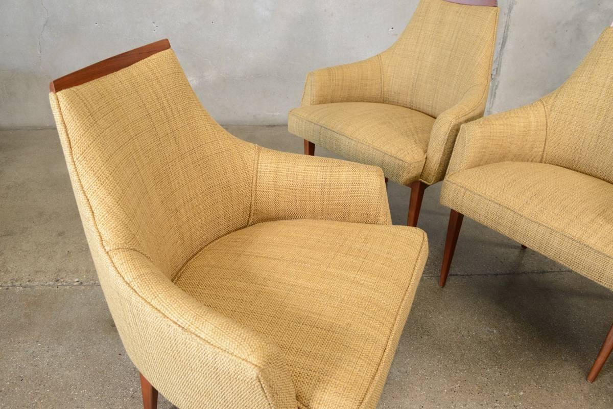 Beautiful set of four walnut and upholstered dining chairs designed by Kipp Stewart for Calvin Furniture. These chairs are for someone who really wants to enjoy their dining experience. Extremely comfortable with a wide and deep seat, these could