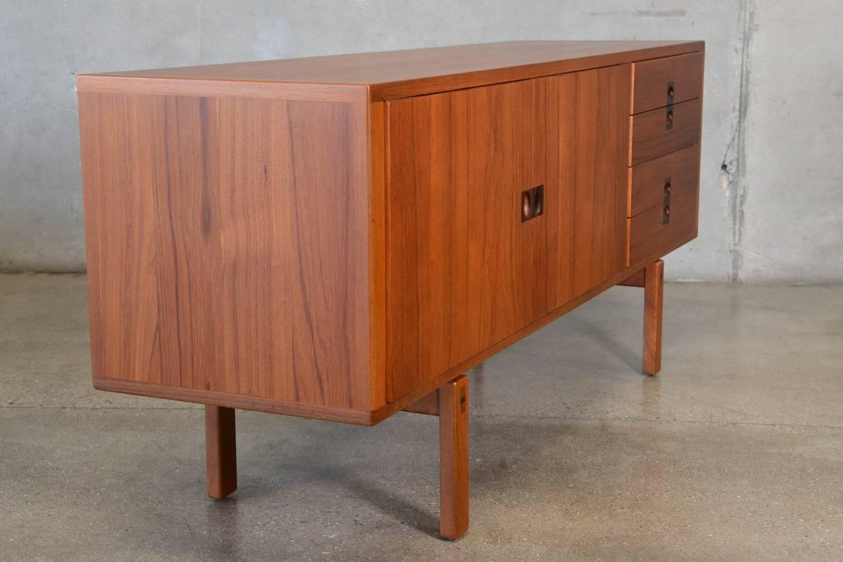 A stunning piece designed by Lennart Bender for Ulferts of Sweden as part of the 'Corona' line. Constructed of beautiful teak with sculpted rosewood pulls and tenon details on the legs. The fully finished back allows this piece to float in a room.