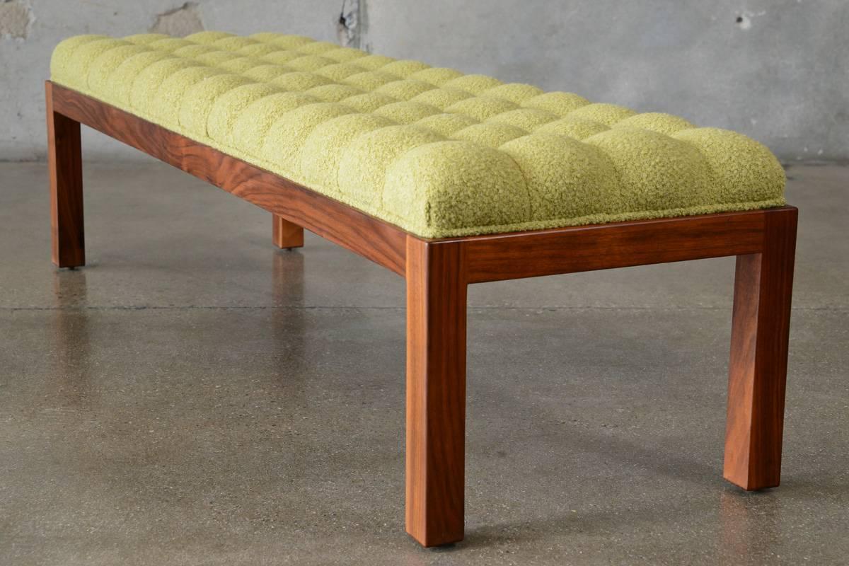 This long button tufted bench is a fantastic piece, featuring a solid walnut Parsons style frame with a button tufted top that has been reupholstered in a fantastic cashmere bouclé. This piece dates to the 1950s and has been completely restored and