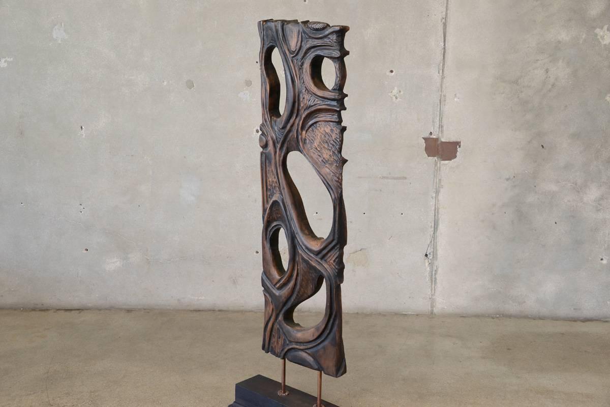 A carved walnut screen mounted on a wood base by artist George Mullen. He referred to this a pierced walnut screen because of the pass through holes. This piece is carved on both sides and each is unique. This is one of a number of pieces we
