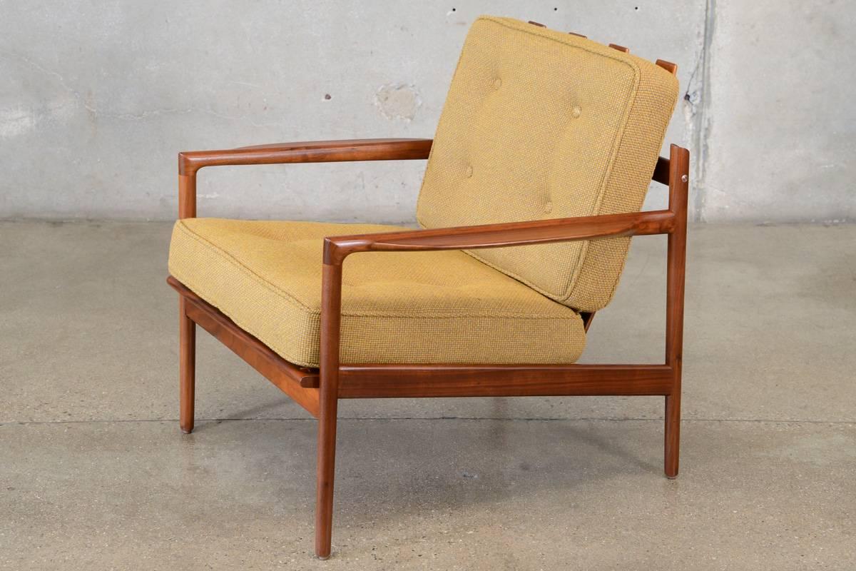 A rare walnut 'picket back' lounge chair designed by Kofod Larsen for Selig. A beautiful sculptural design with a lot of very nice details. This piece has been fully restored and is in excellent condition. The cushions have been reupholstered in a
