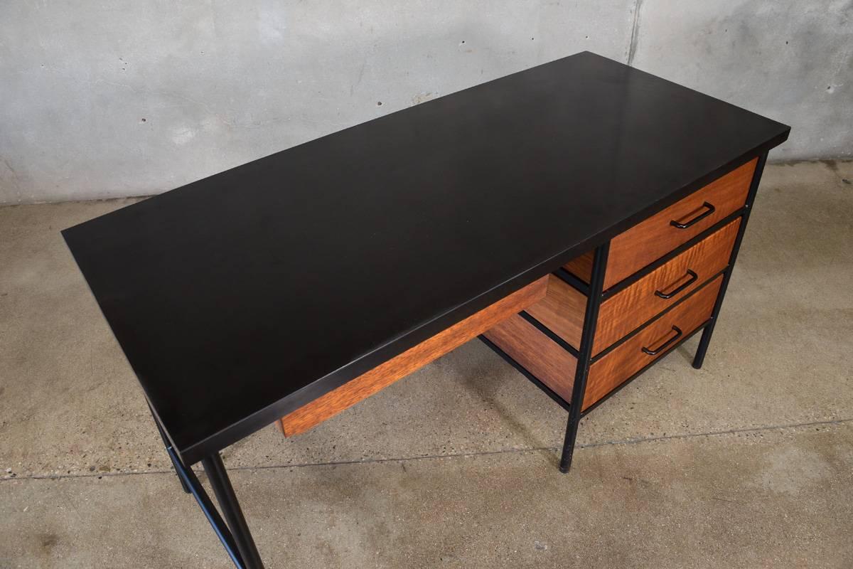 Classic California Modern design, making the most of the lest materials. This simple desk by Vista of California contrasts beautiful mahogany drawers against black painted steel and a heavy duty black laminate top. The metal framing leaves the