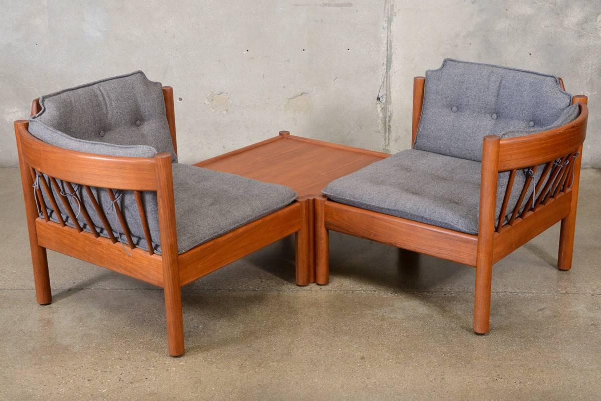 A unique three-piece set, with two chairs and a table that can be used in multiple configurations. The chairs each have one arm allowing them to be used as a loveseat when pushed together. They can also be used on either side of the table, either in