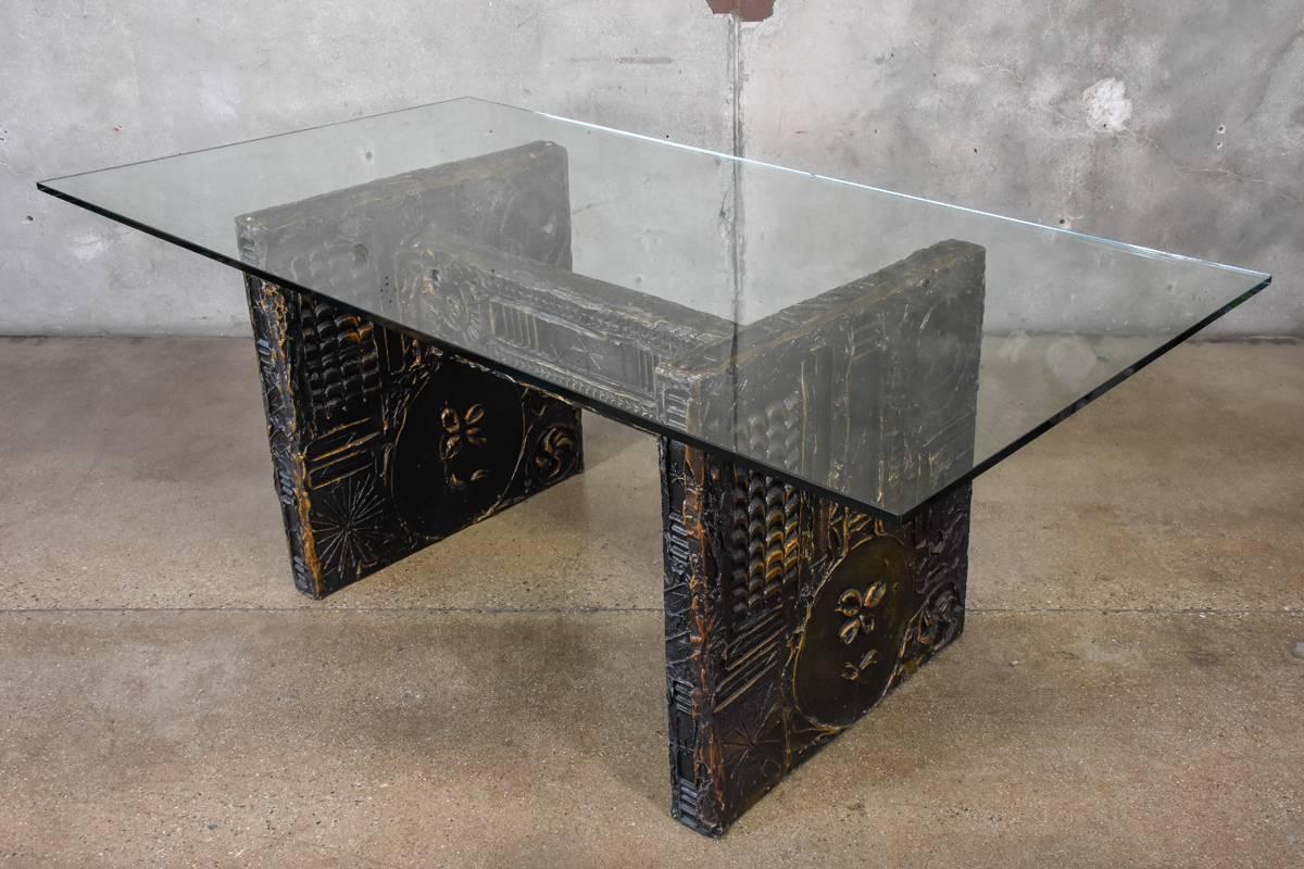 A Brutalist dining table with glass top designed by Adrian Pearsall, very reminiscent of work by Paul Evans. The base is sculpted and painted resin, giving it a somewhat metallic look. The base is in very good condition. The glass top shows