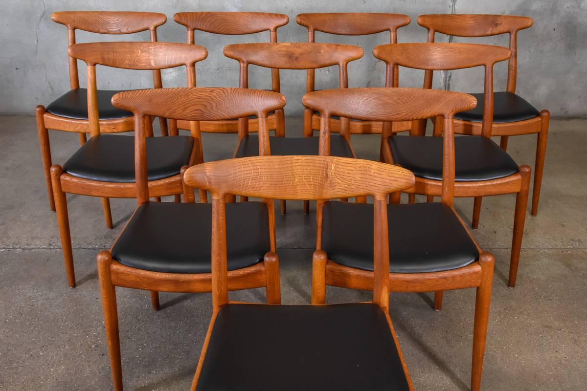 A set of ten model W1, oak dining chairs designed by Hans Wegner for C.M. Madsens in 1953. A classic design that you rarely find in such large sets. These examples have been cleaned and oiled, and the seats have been upholstered in a high quality